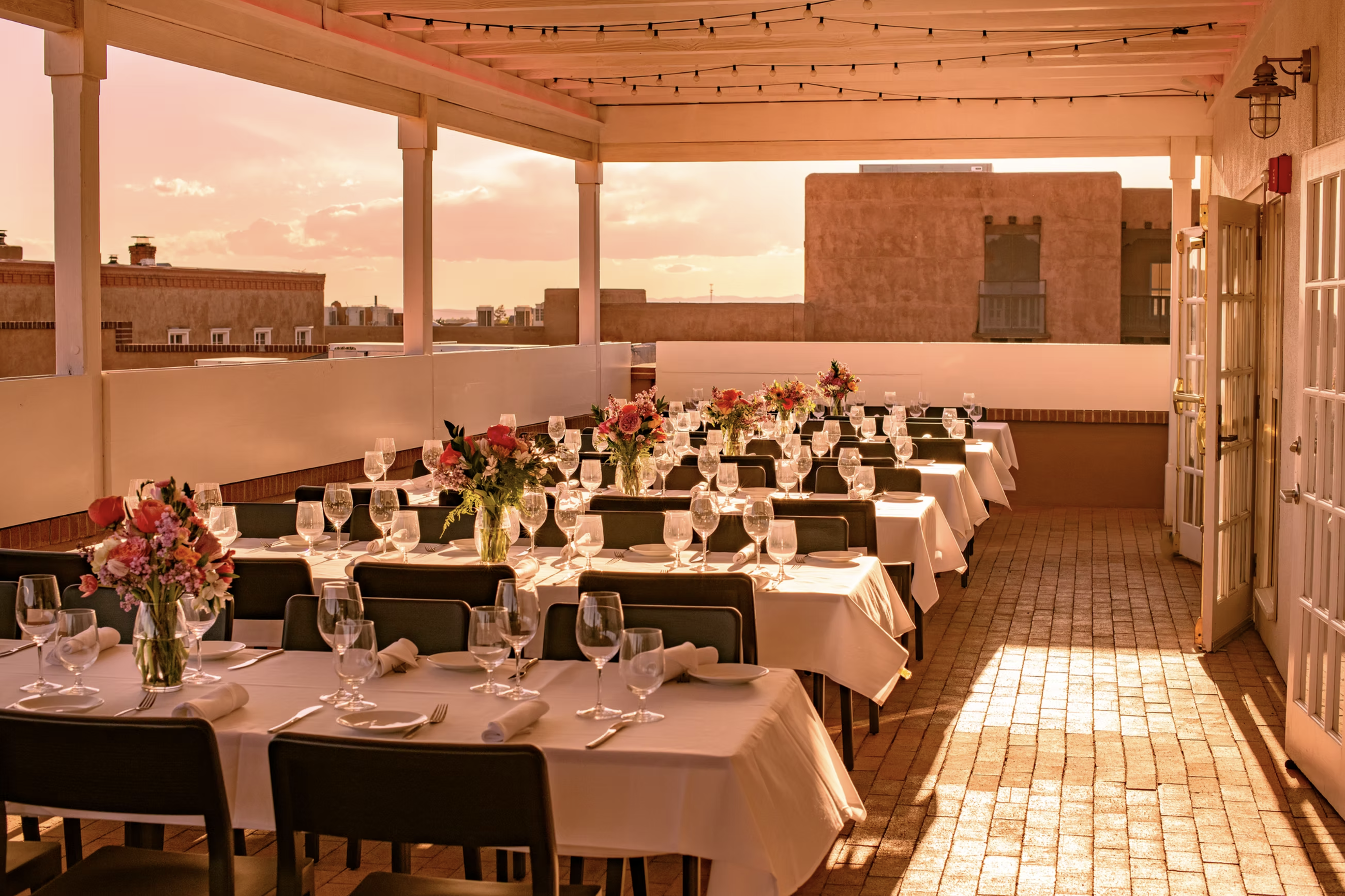 Spectacular panoramic views from The Sunset Terrace, highlighting Santa Fe's cityscape and mountains at sunset.