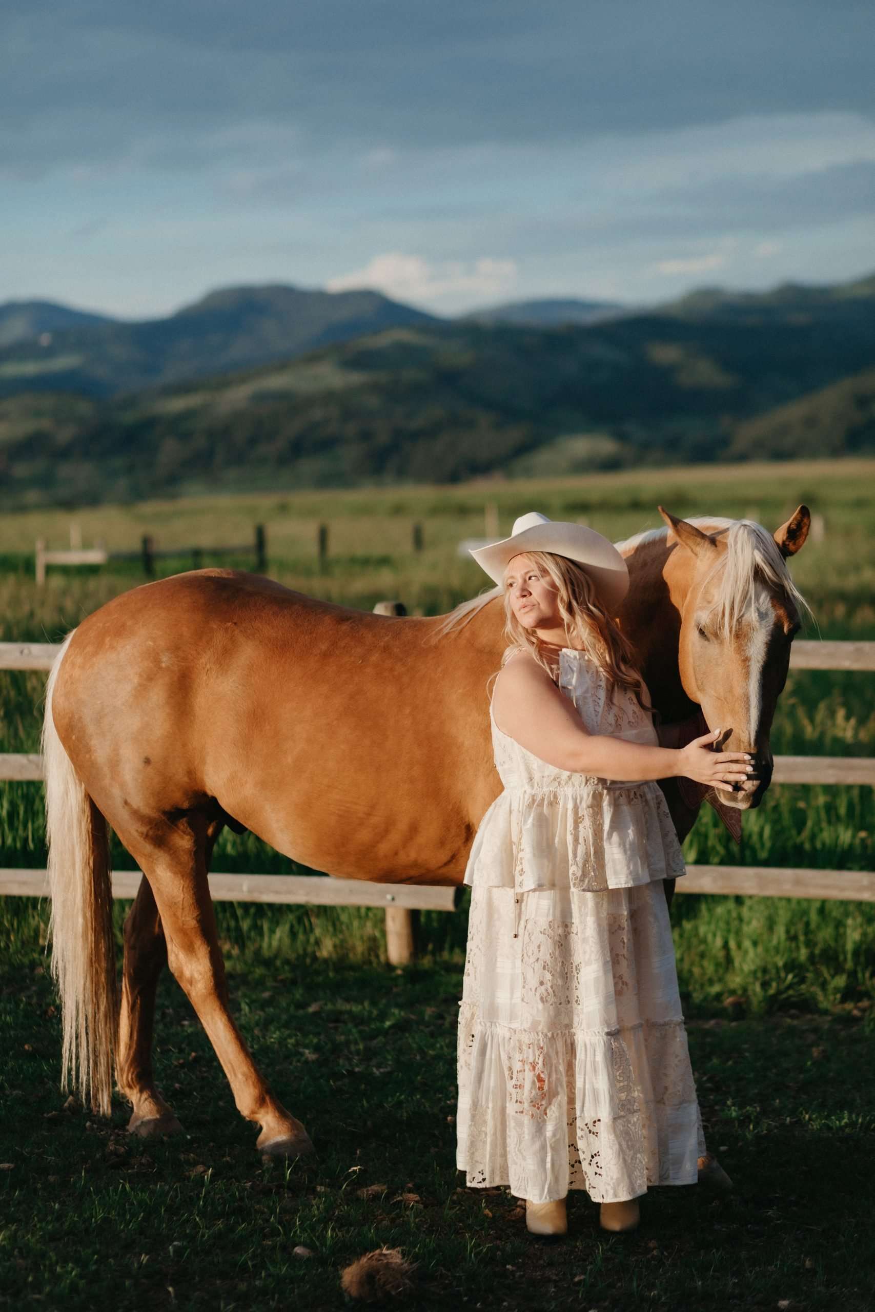 bride in western dress with horse on a farm