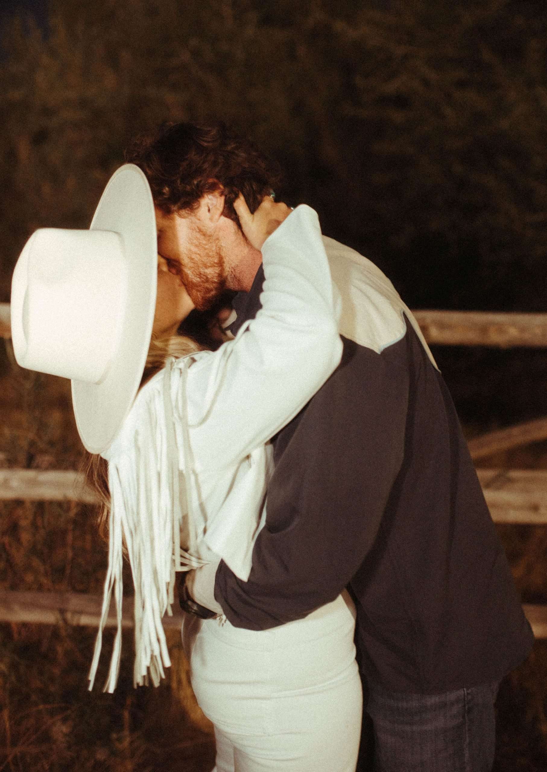 bride and groom kissing at rehearsal dinner