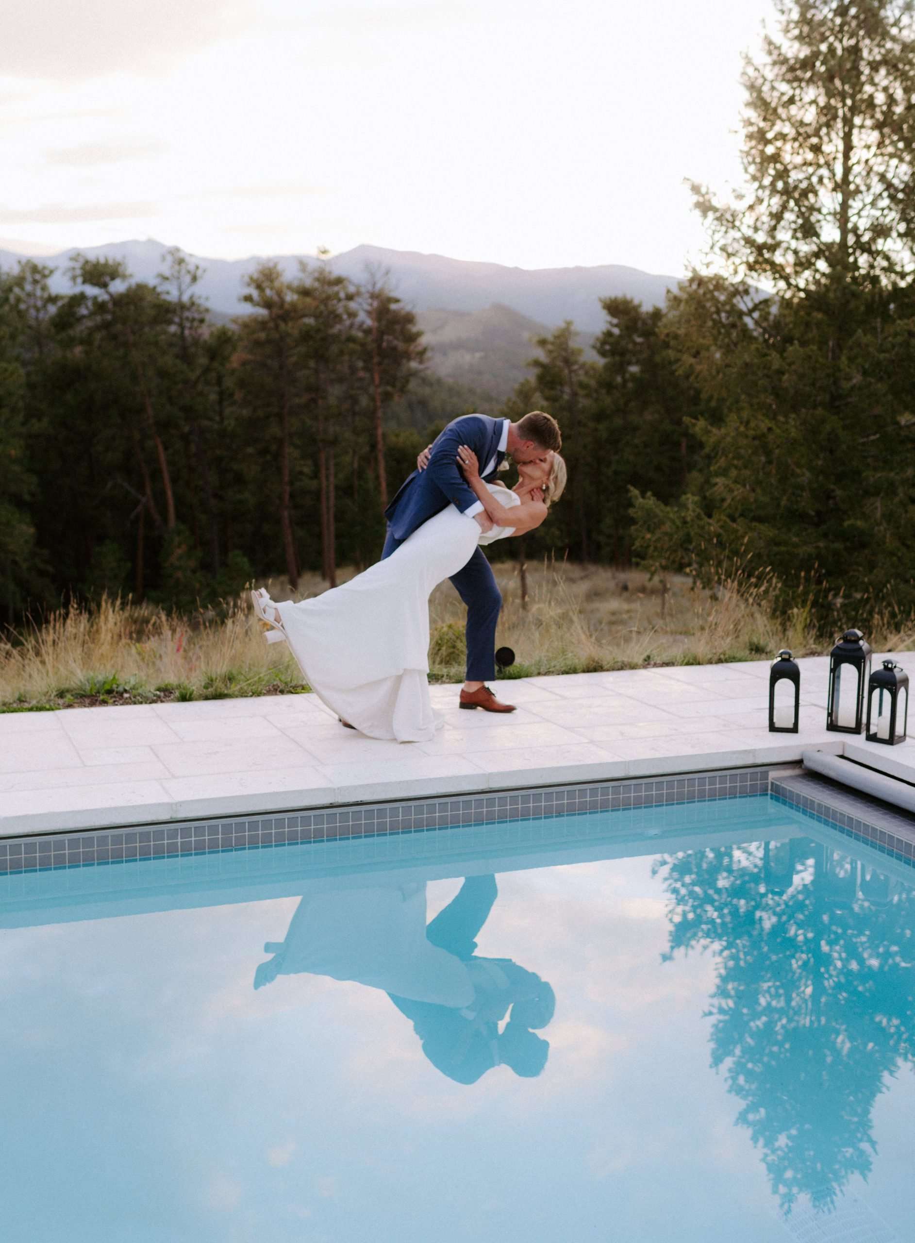 couple dip and kiss during a colorado wedding