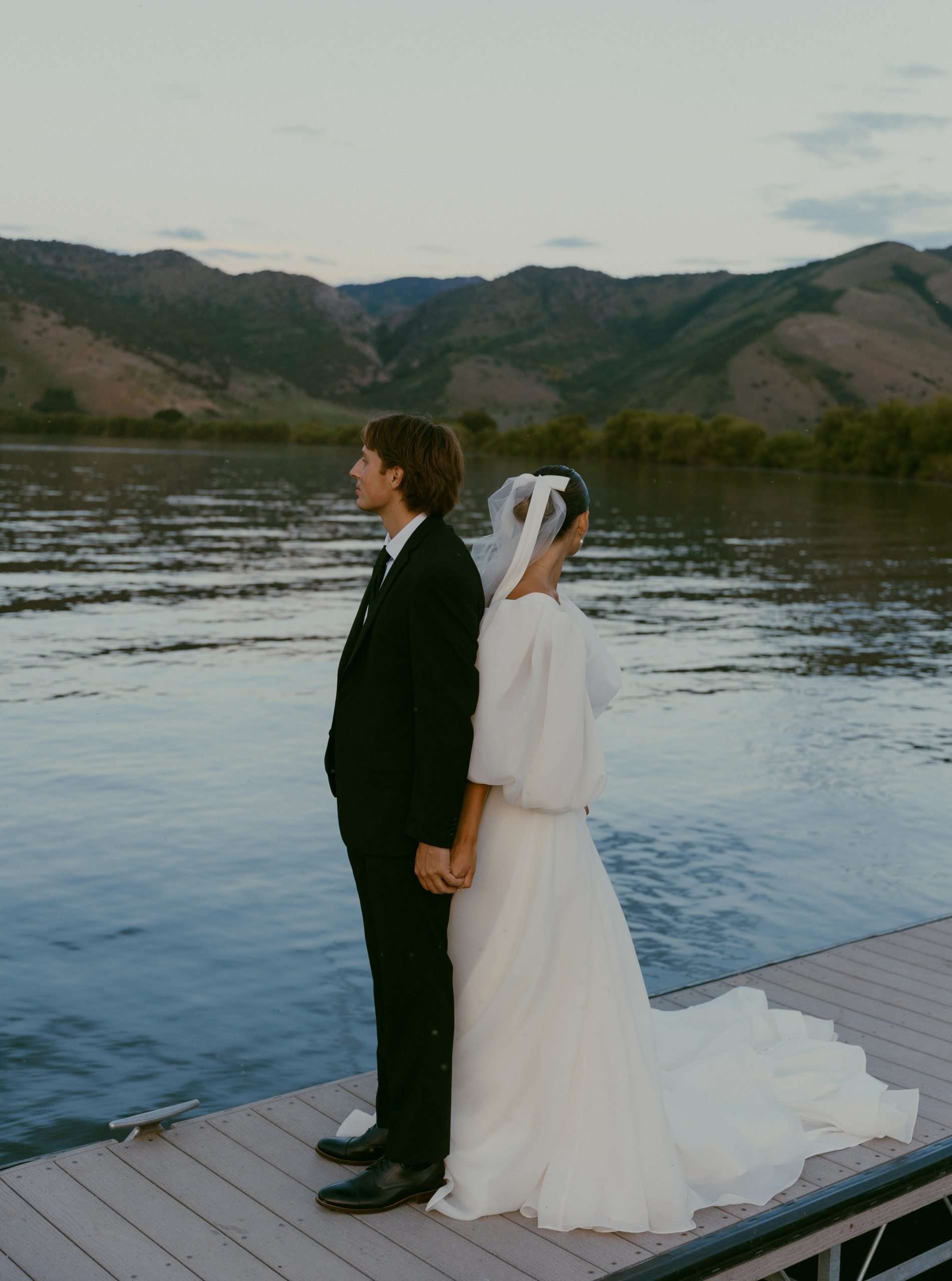 bride and groom looking out at utah lake utah wedding bridal photos