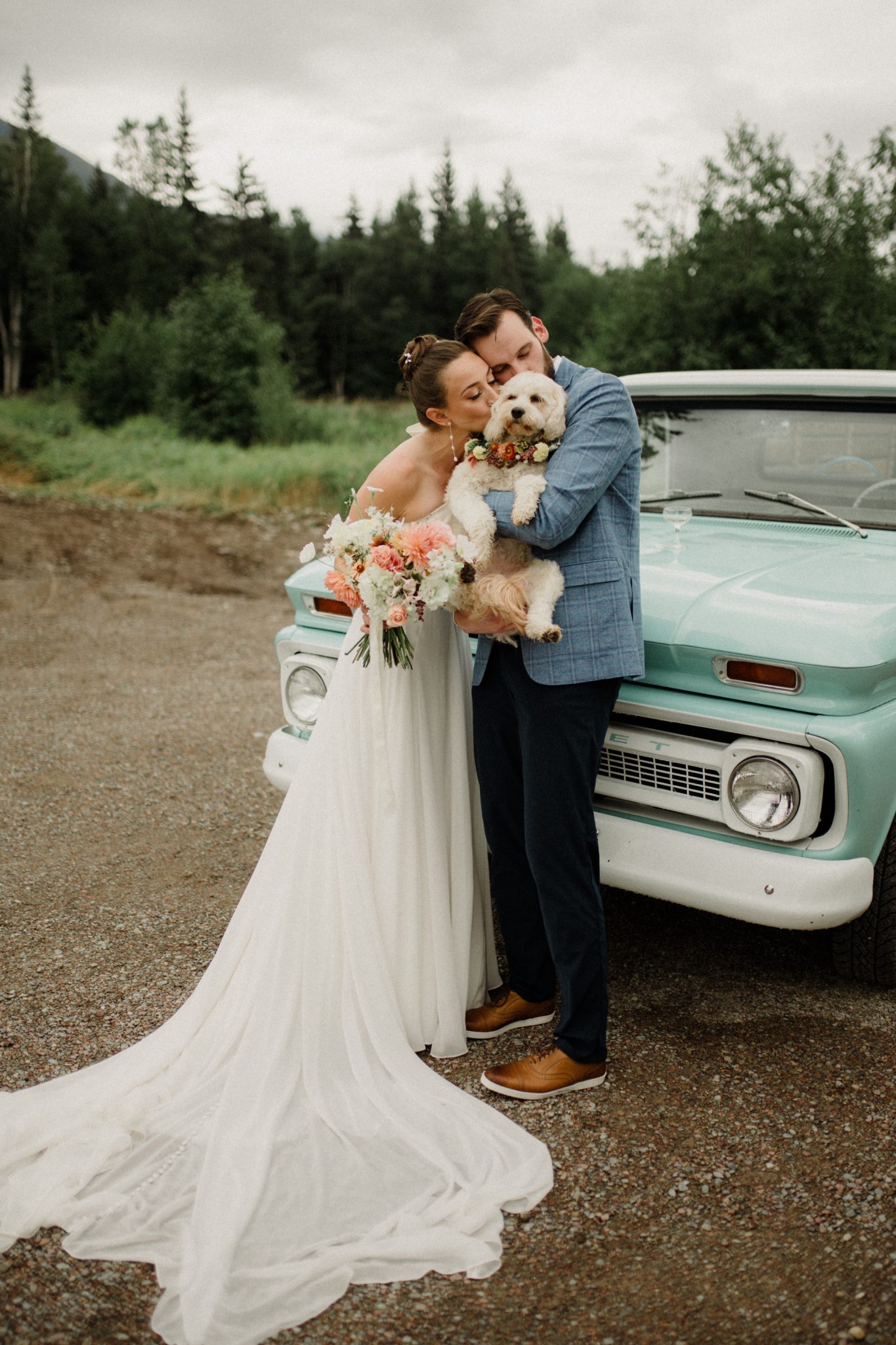 bride and groom with their dog for their montana summer wedding