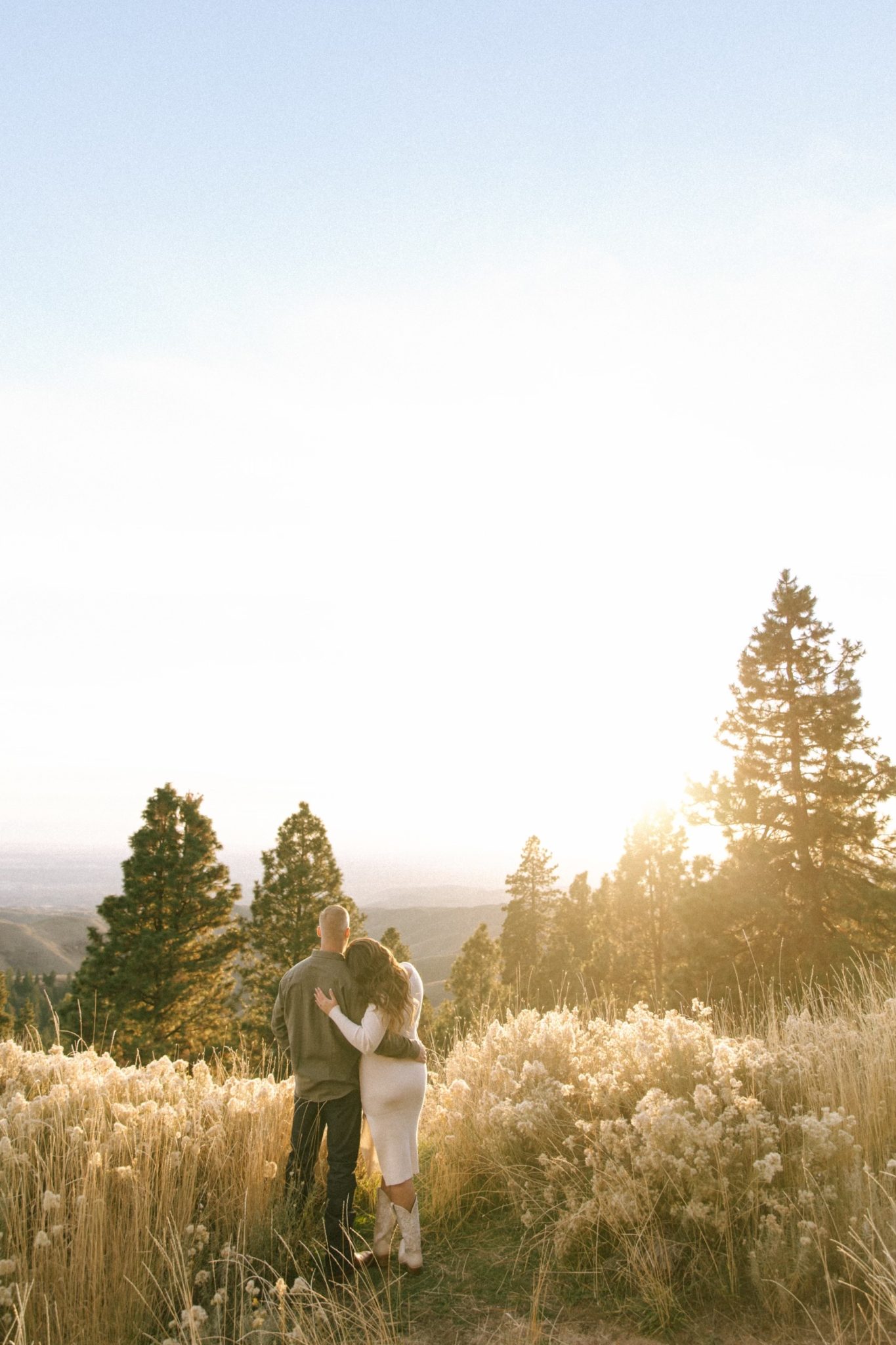 couple gazing off into the distance appreciating Idaho's beauty for their Boise Idaho Winter Engagement Session