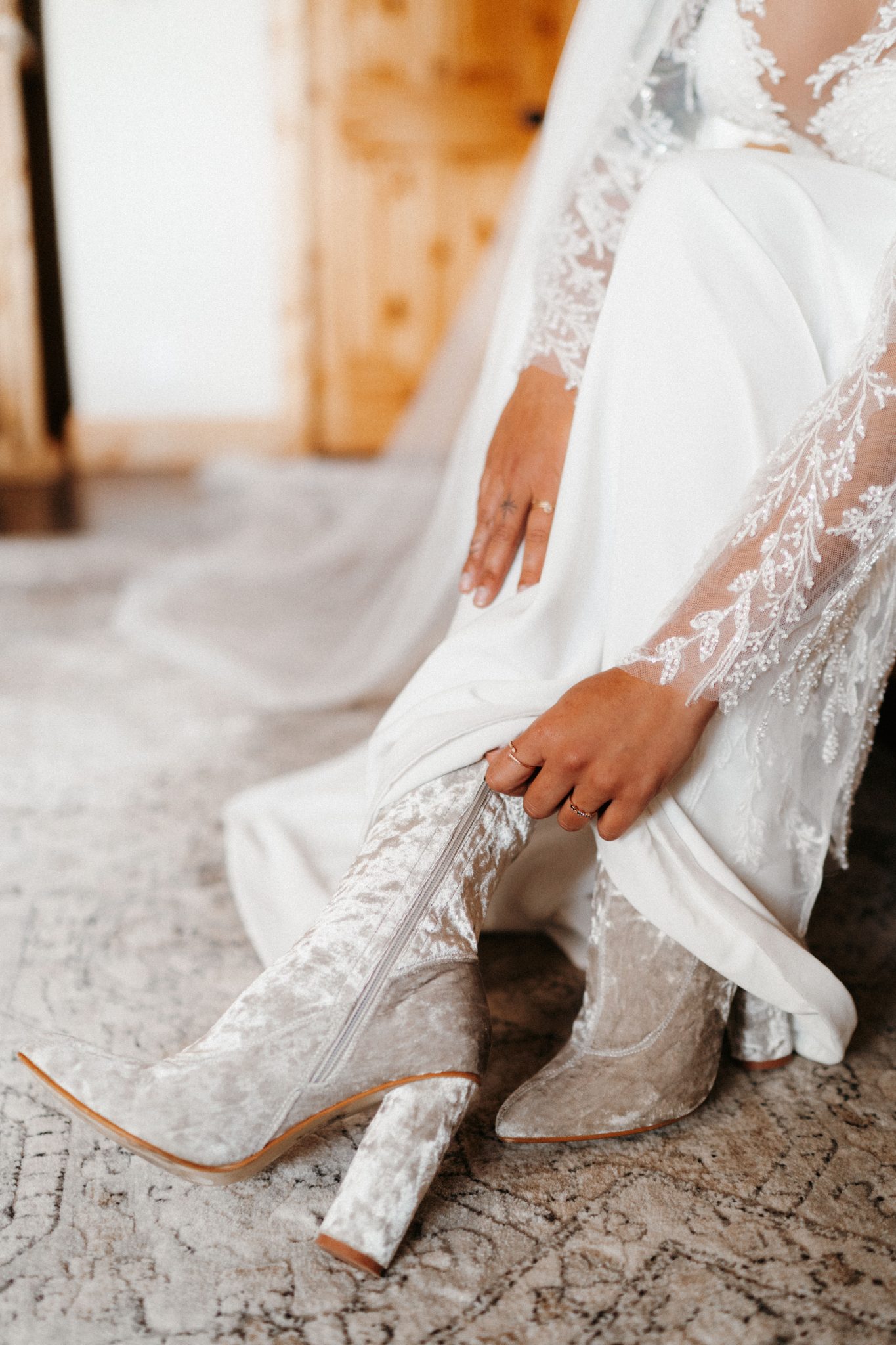 bride putting her velvet boots on Pikes Peak Ranch Styled Shoot