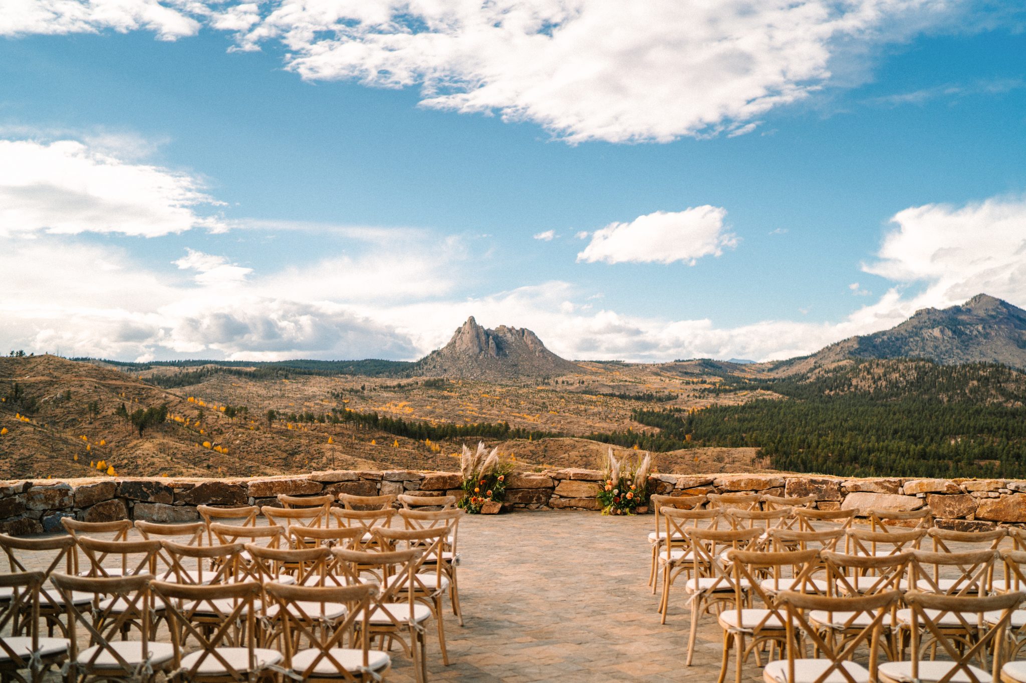 fall foliage peaking from the background at the ceremony site for Pikes Peak Ranch Styled Shoot