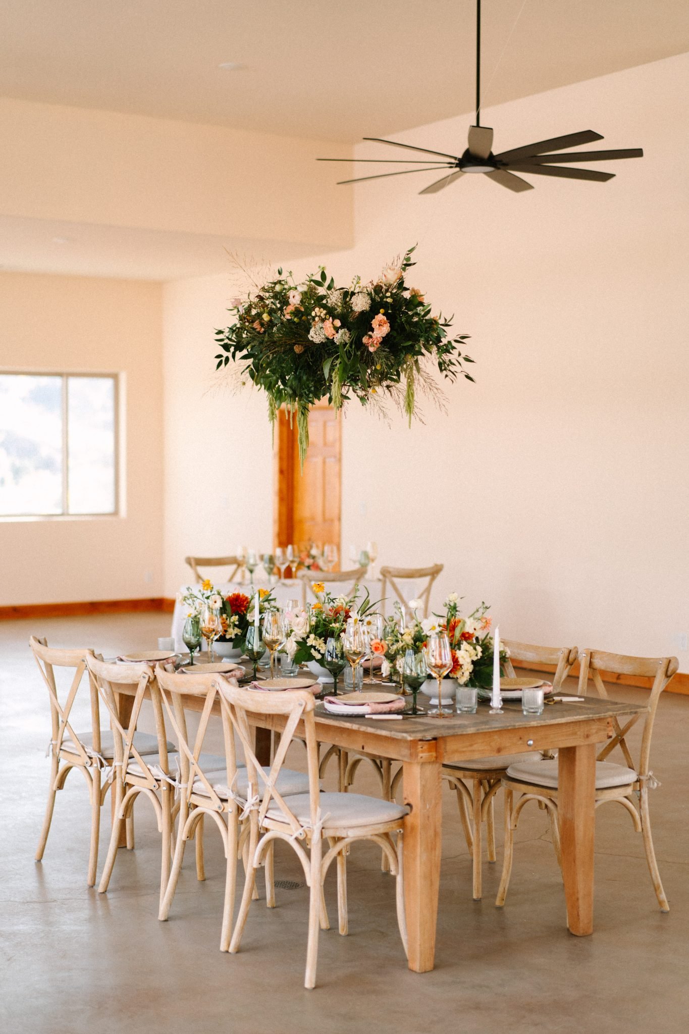 Pikes Peak Ranch Styled Shoot reception room with hanging floral over the wooden table