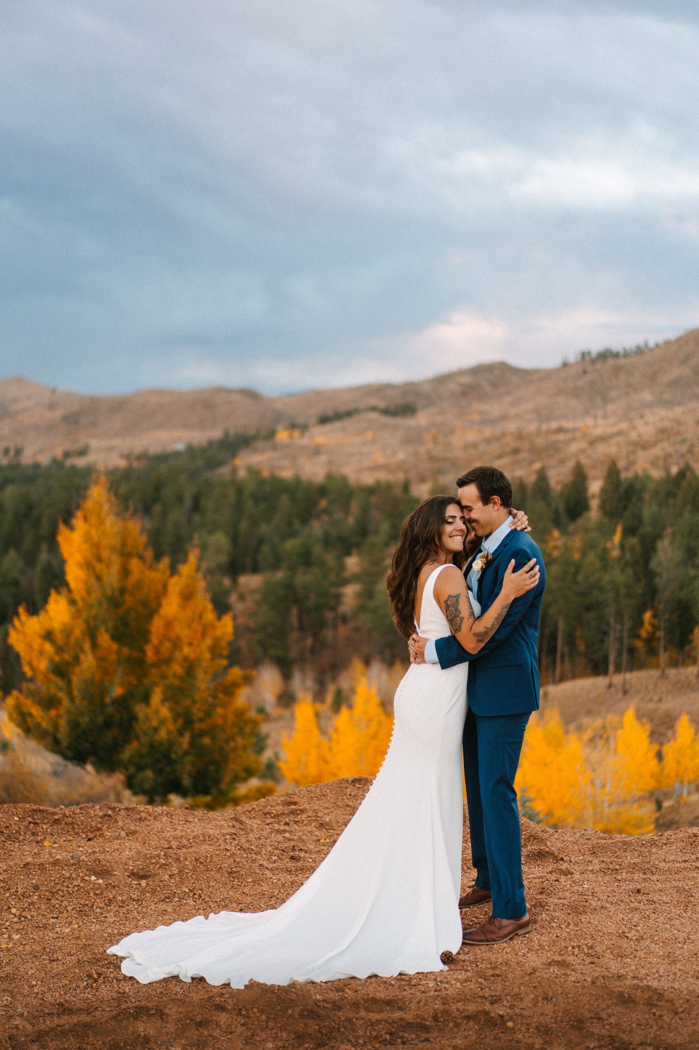 couple surrounded by fall foliage Pikes Peak Ranch Styled Shoot