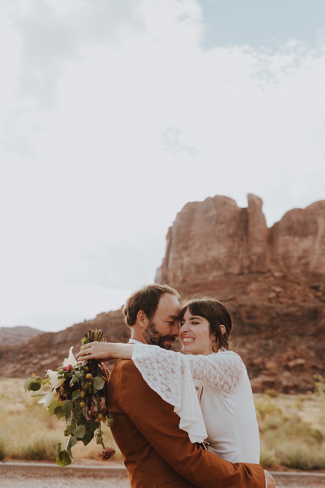 couple flirting while she holds her bouquet The Red Earth Venue Wedding Inspiration