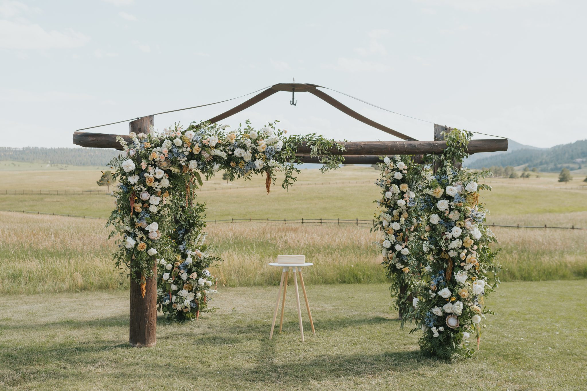lush ceremony arch for a spruce mountain ranch summer wedding