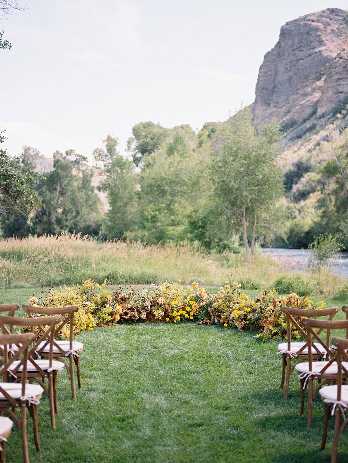 Low ceremony florals next to a lake for a Utah Summer Wedding