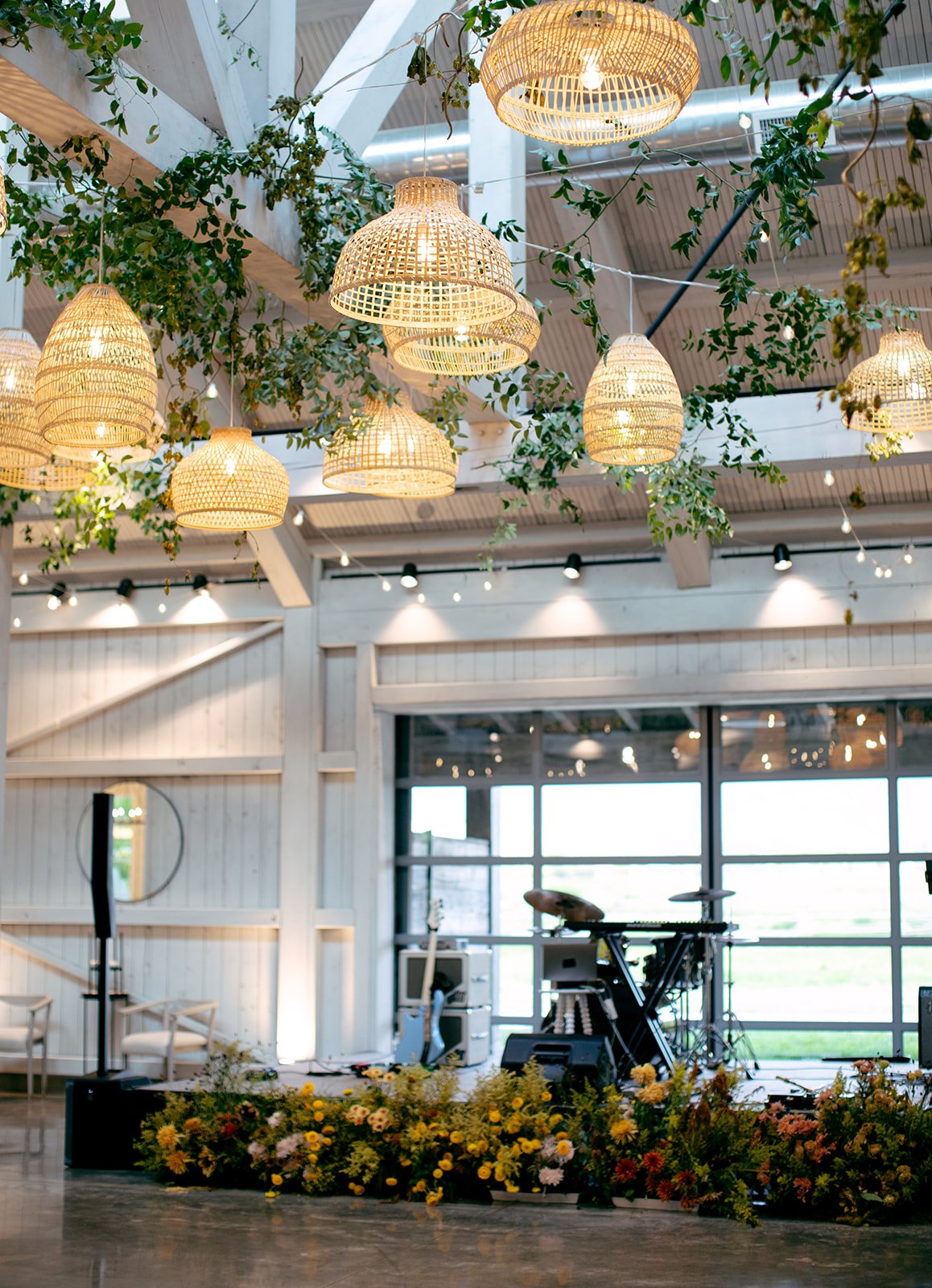 rattan lights with greenery above the dance floor for a Utah Summer Wedding