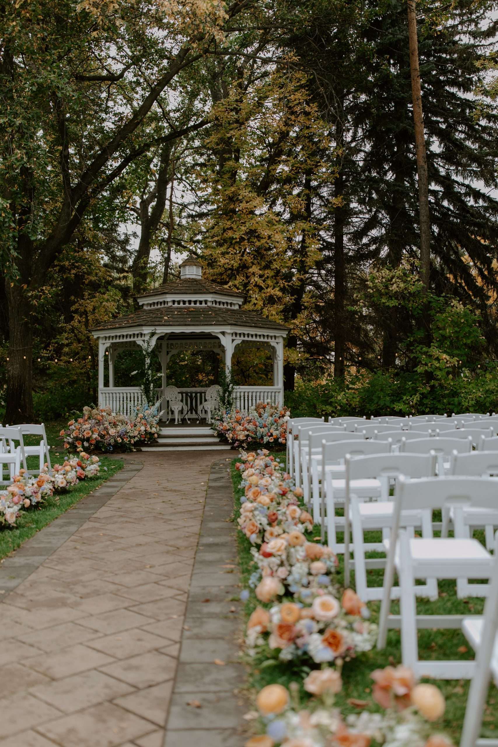 lush florals lining the ceremony aisle for an alberta wedding