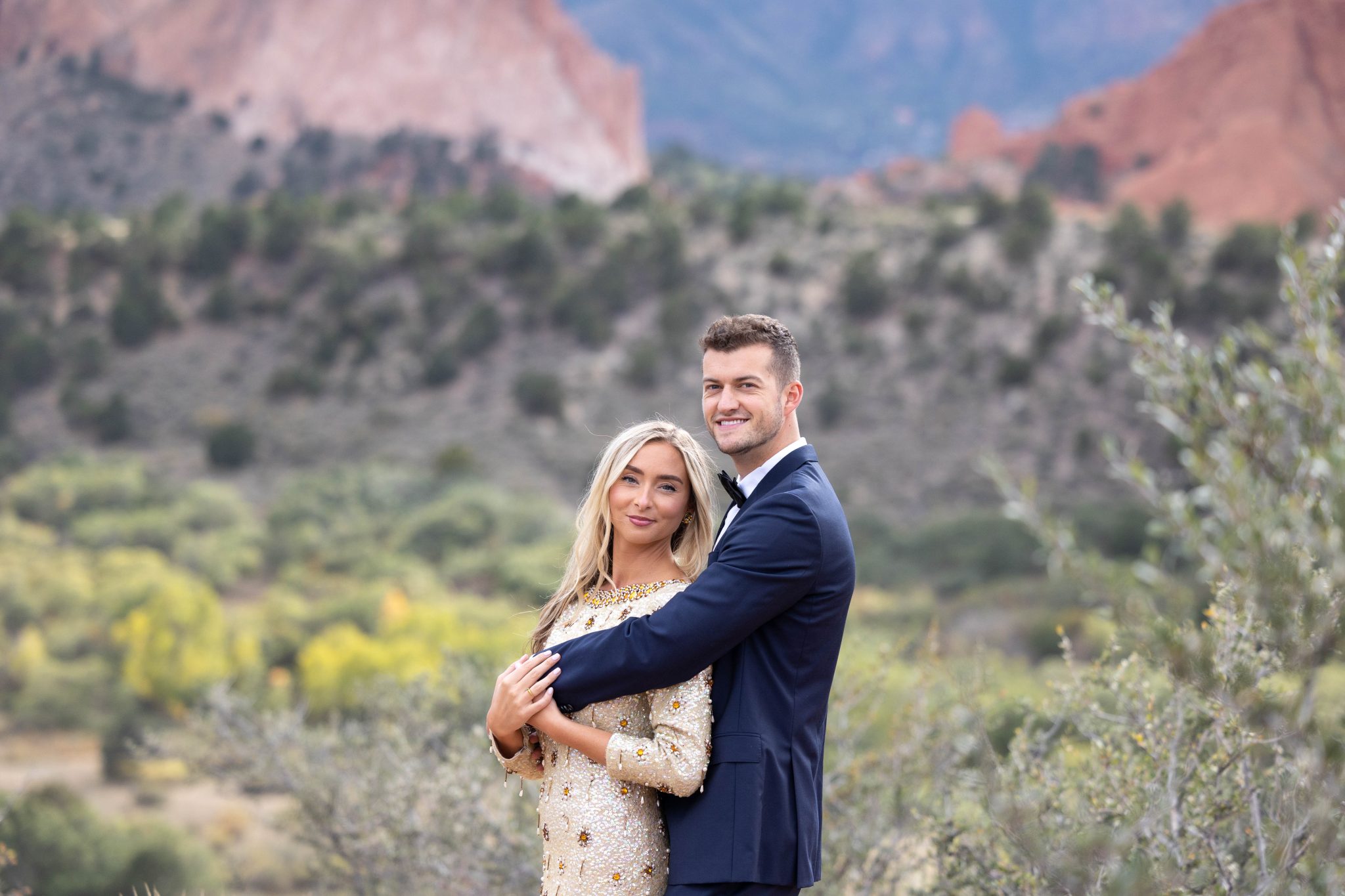 garden of the gods spring engagement session with a tuxedo and formal beaded dress