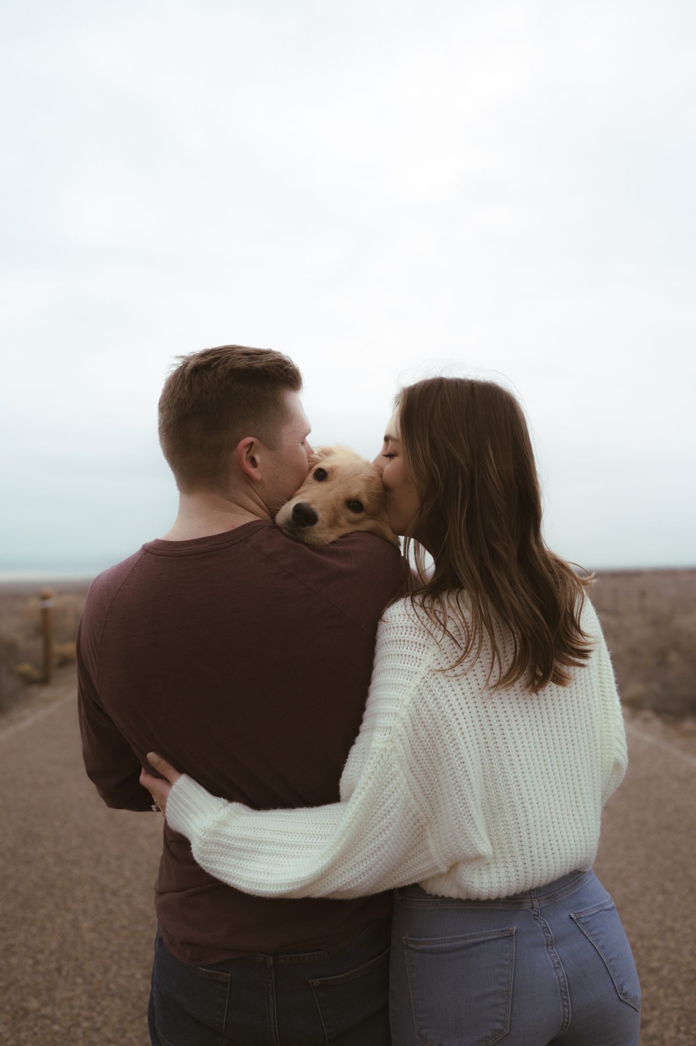 Albuquerque New Mexico Fall Engagement couple kissing their cute puppy