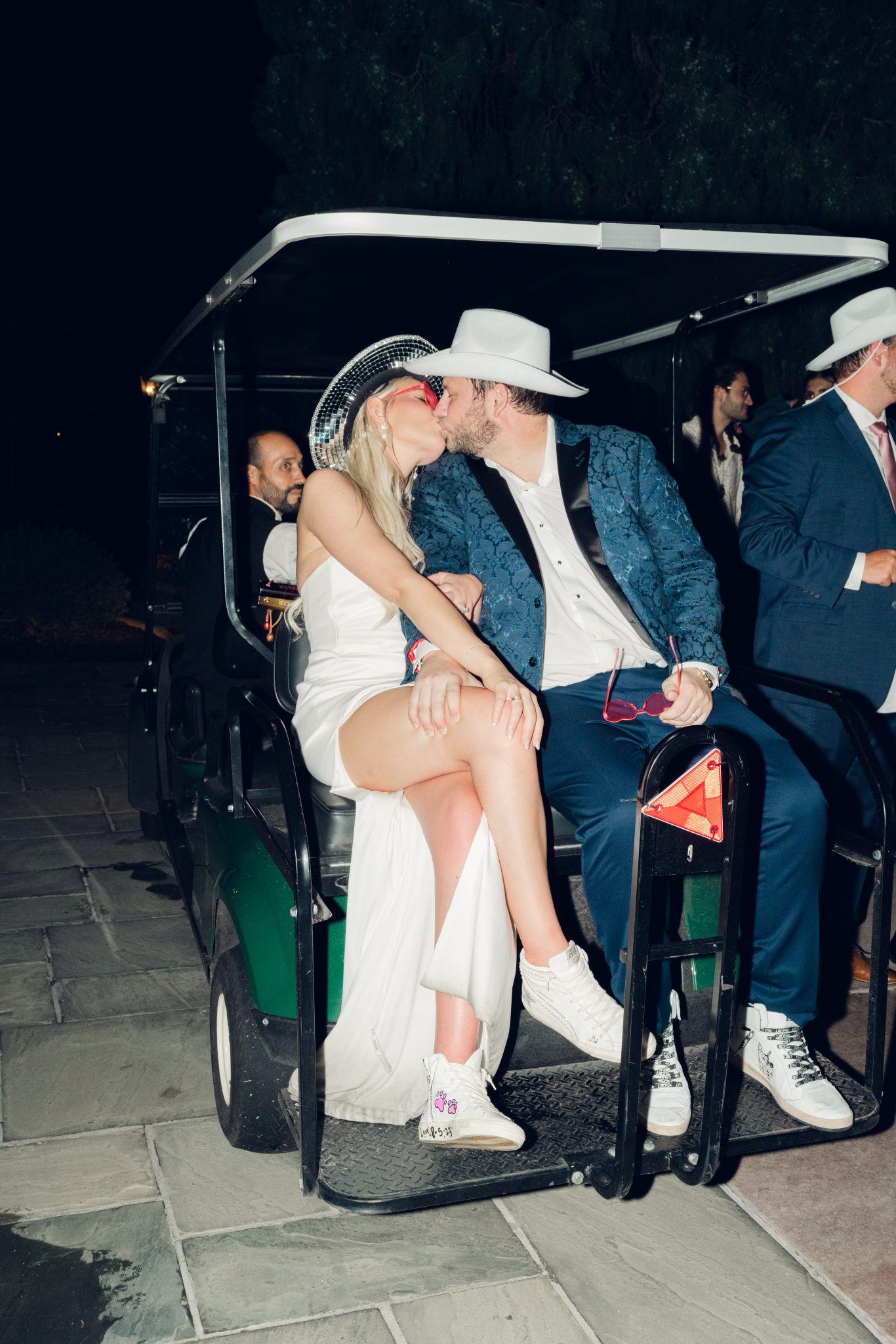 Colorado Springs Summer Wedding bride and groom kiss in the Broadmoor hotel's golf cart after the grand exit
