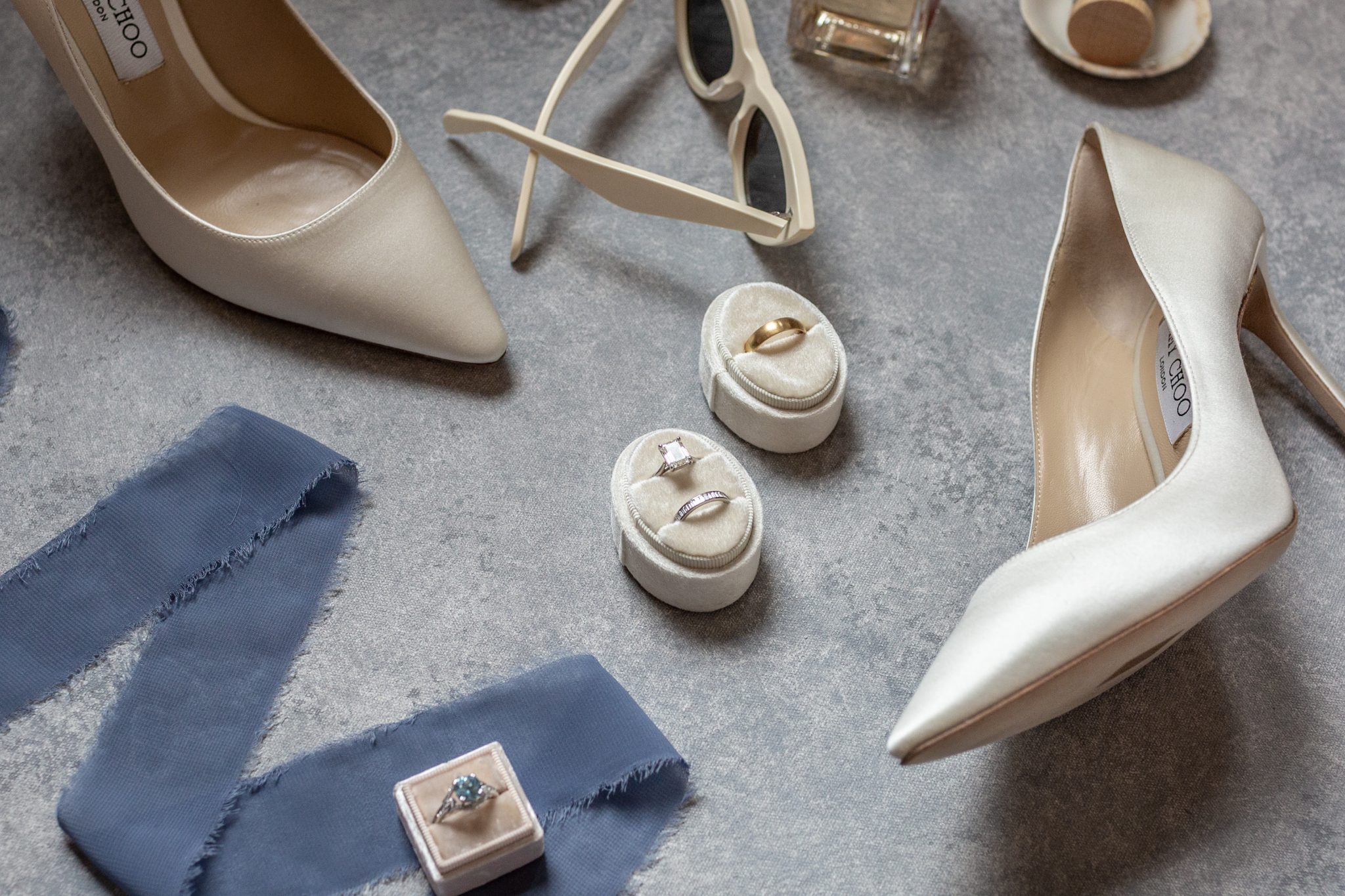 Denver Botanic Gardens Colorado Wedding detail photo of the bride's shoes, rings, perfume, and sunglasses