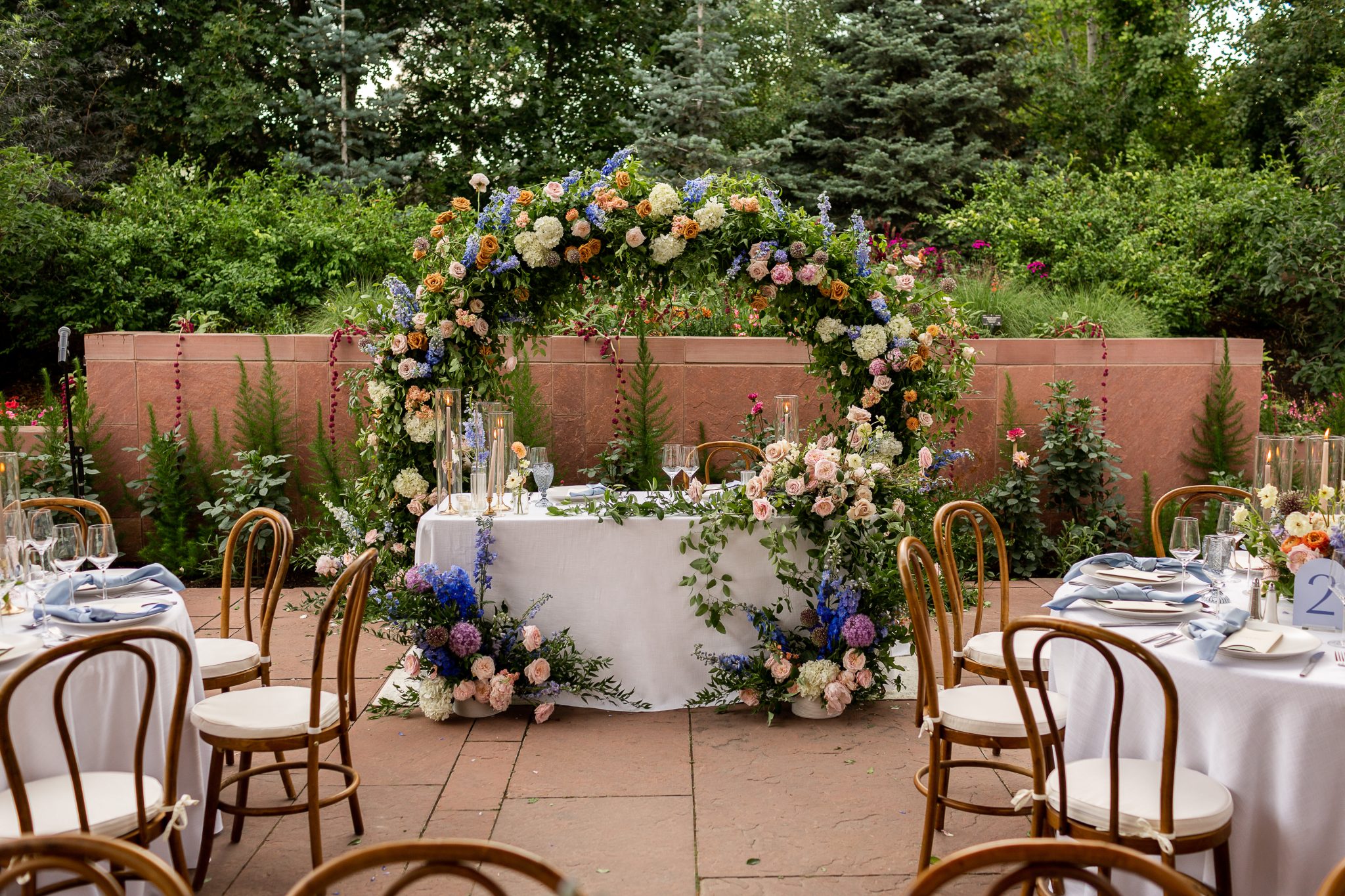 Denver Botanic Gardens Colorado Wedding ceremony floral piece repurposed as sweetheart table decor with lush colorful florals