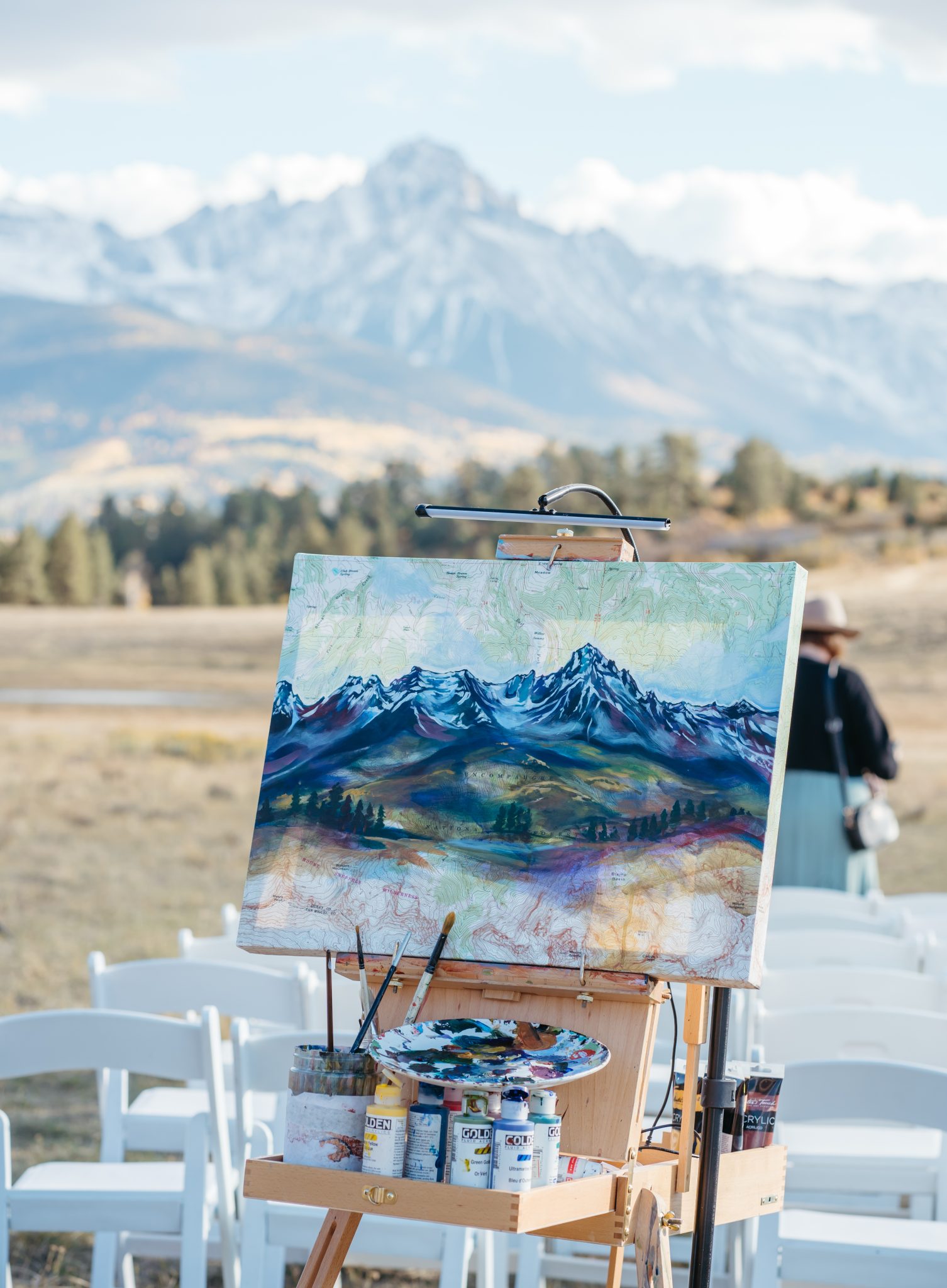 Colorado Fall Wedding couple has a live painter during their ceremony to paint the stunning mountain views