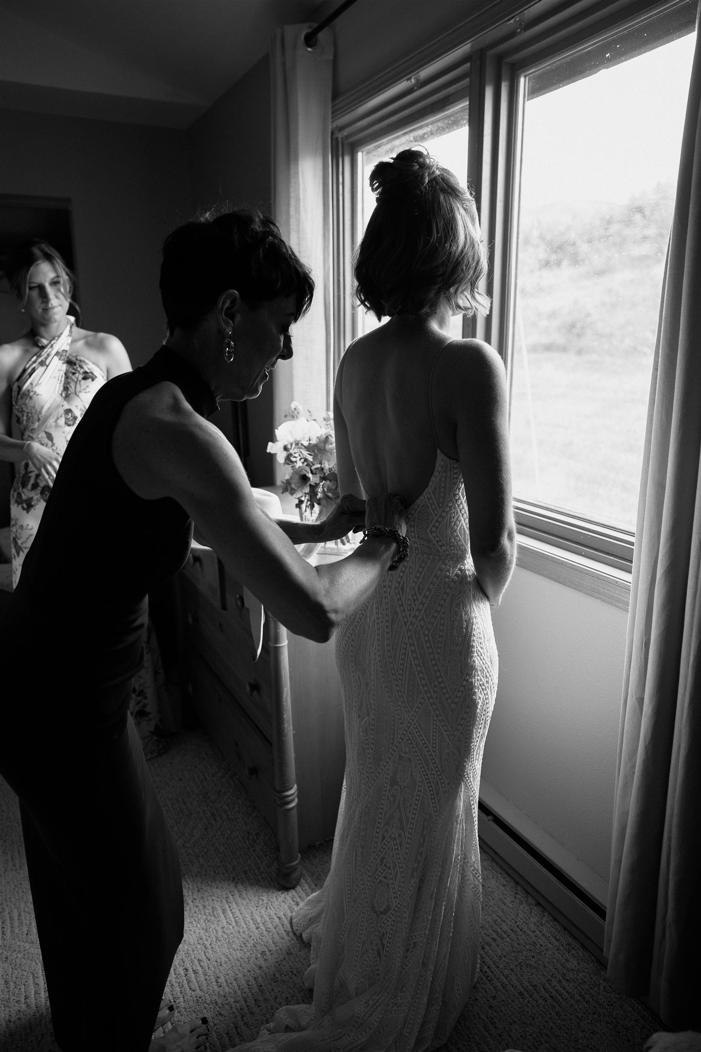 Flying Diamond Ranch Summer Wedding mother of the bride helping the bride get dressed on her wedding day