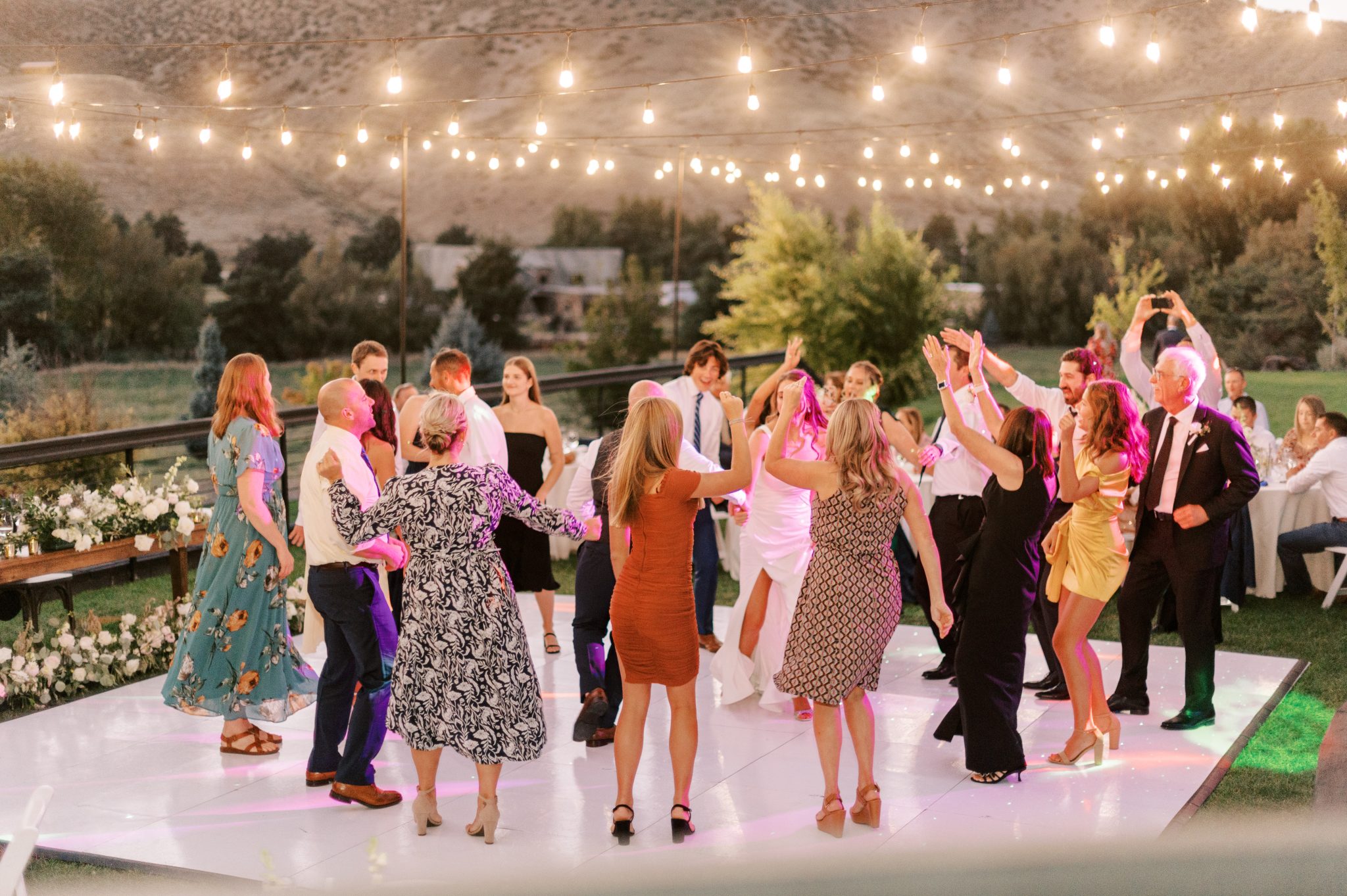 Idaho Summer Wedding guests dancing under market lights