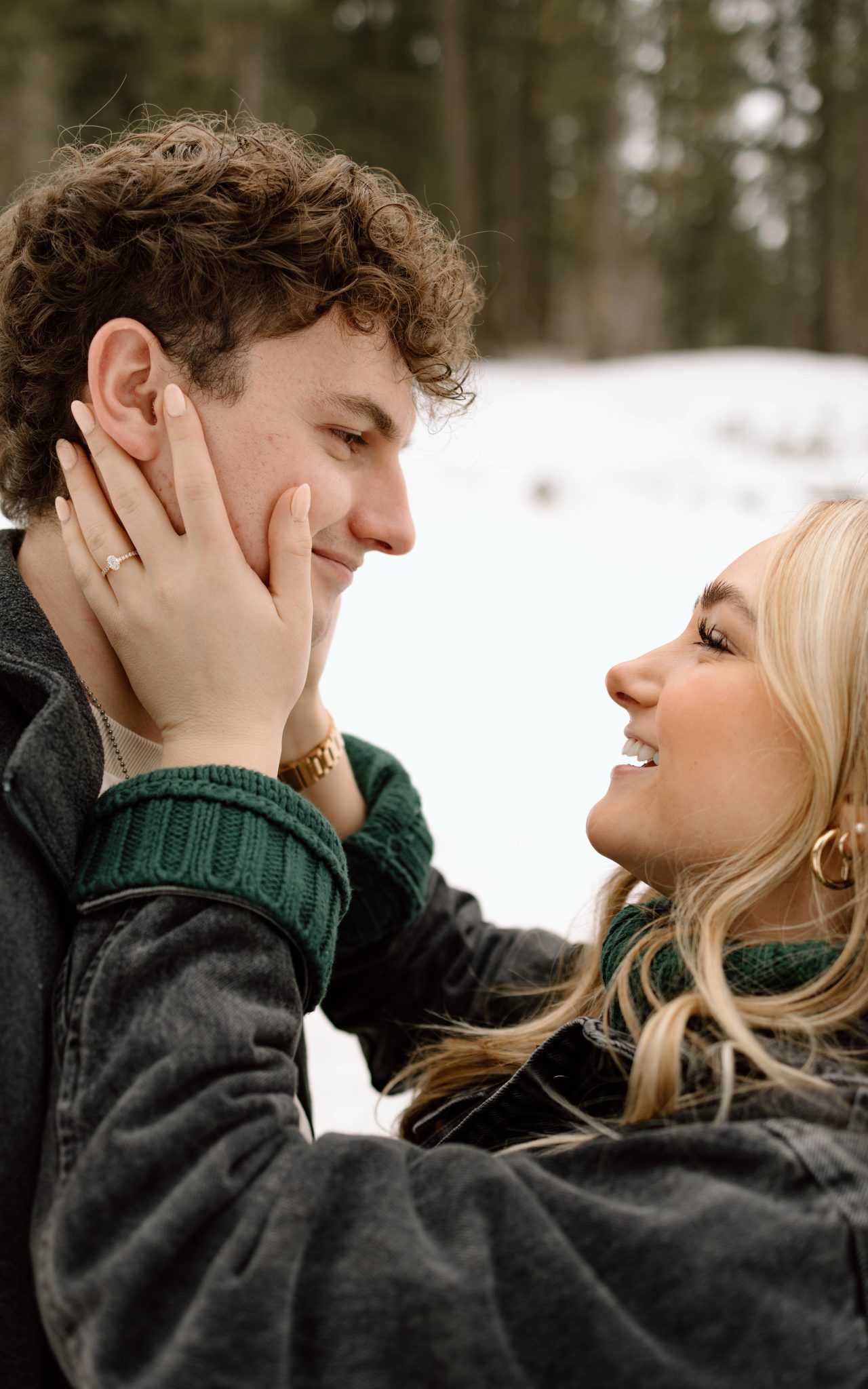 Idaho Winter Engagements her hand is on his face as they look into each other's eyes