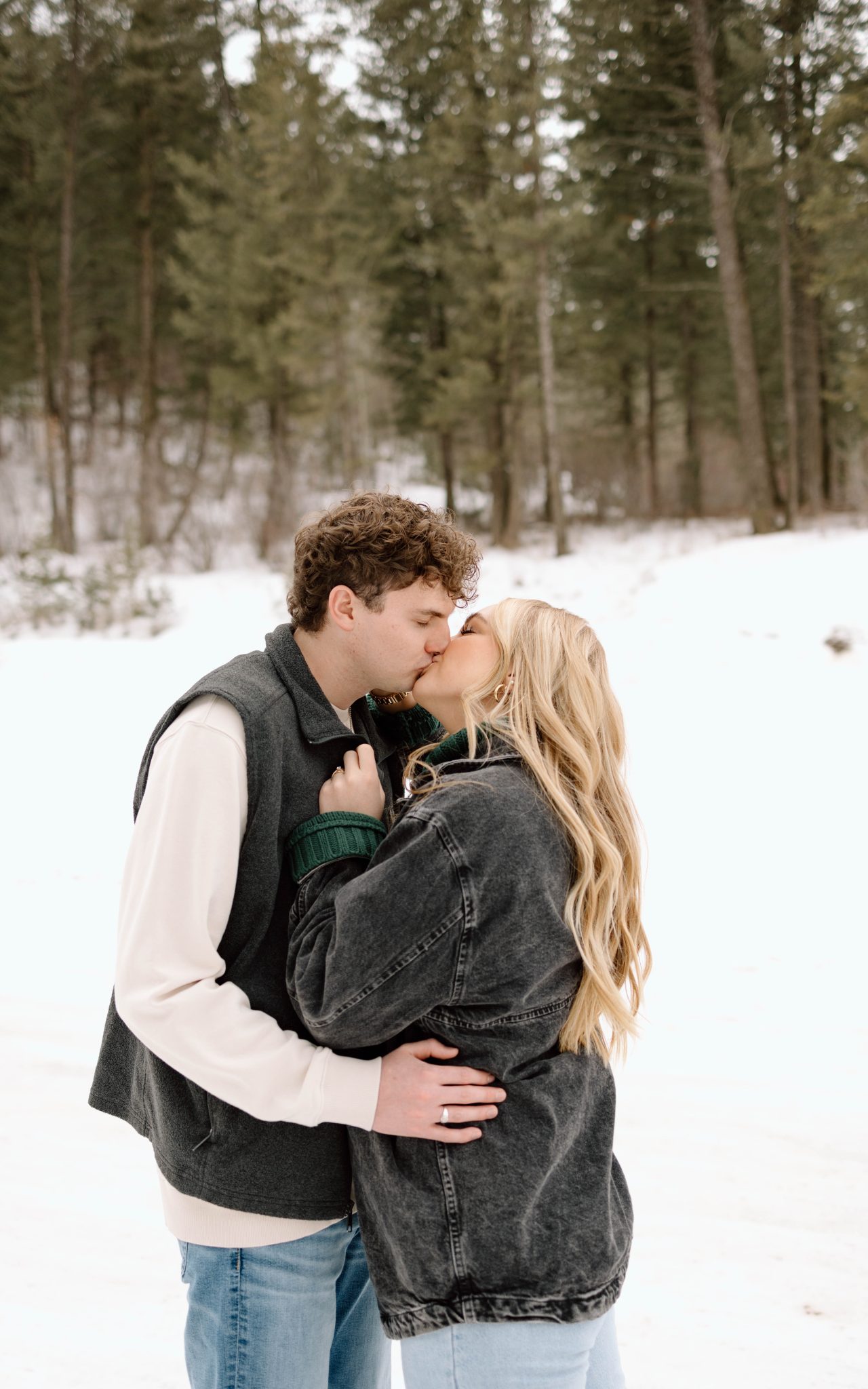 Idaho Winter Engagements couple kissing with cute matching outfits