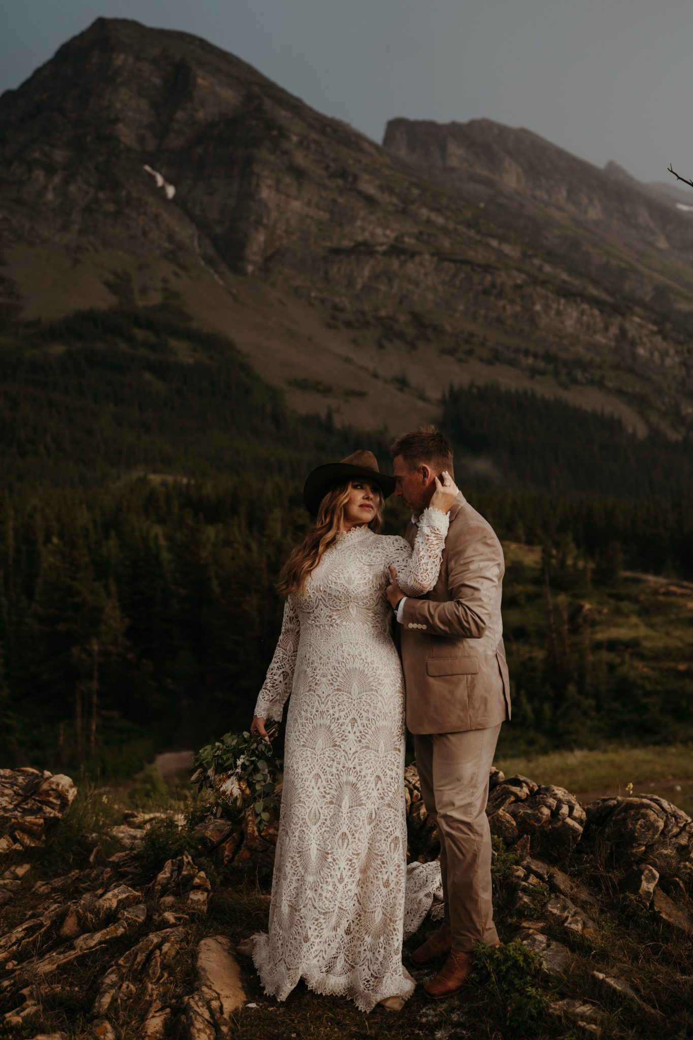 Montana Summer Elopement bride's hand holding the back of the groom's head as they look into each other's eyes with a stunning picturesque background