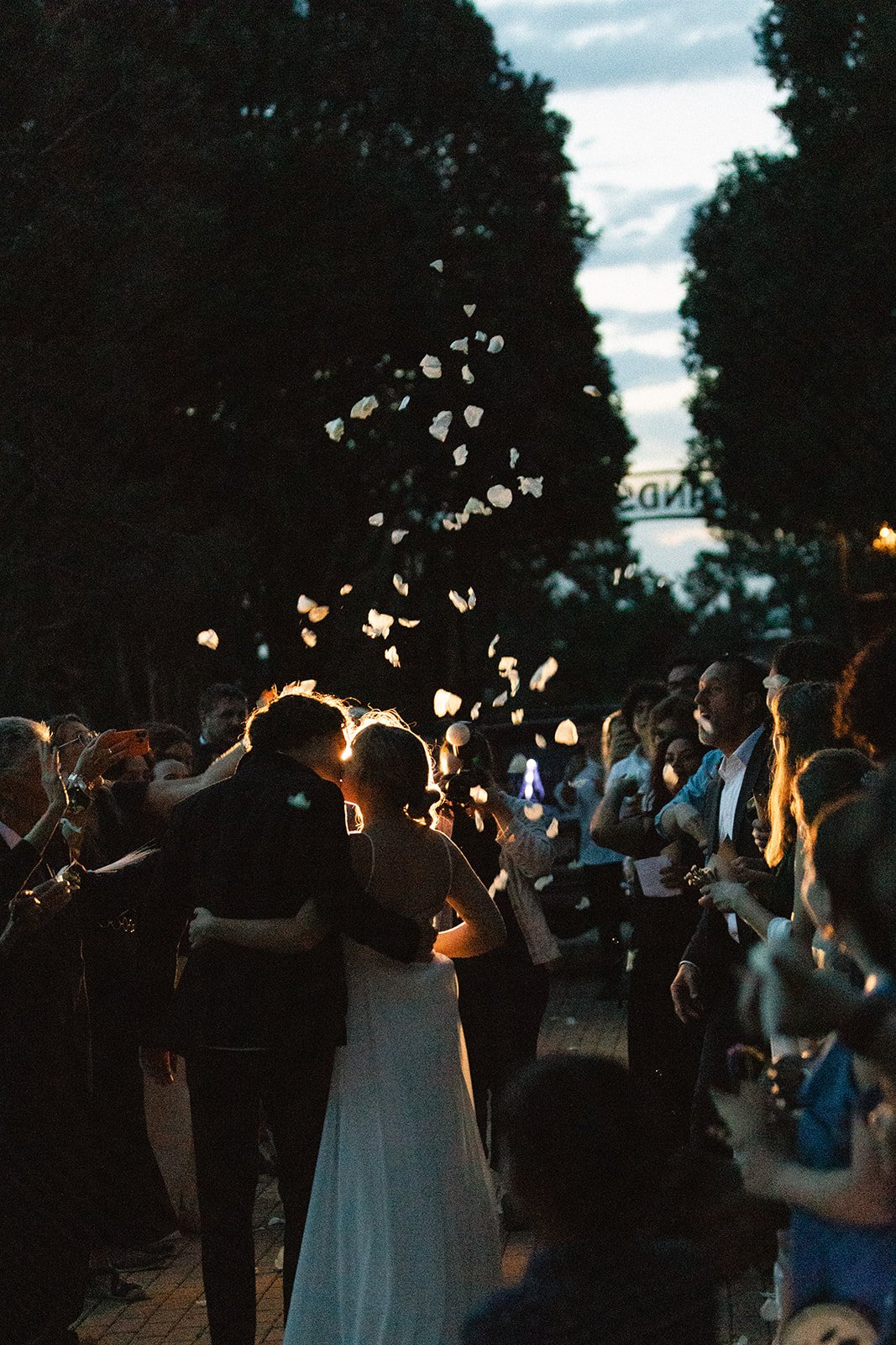 Highlands Ranch Summer Wedding couple exiting their wedding as guests throw white rose petals