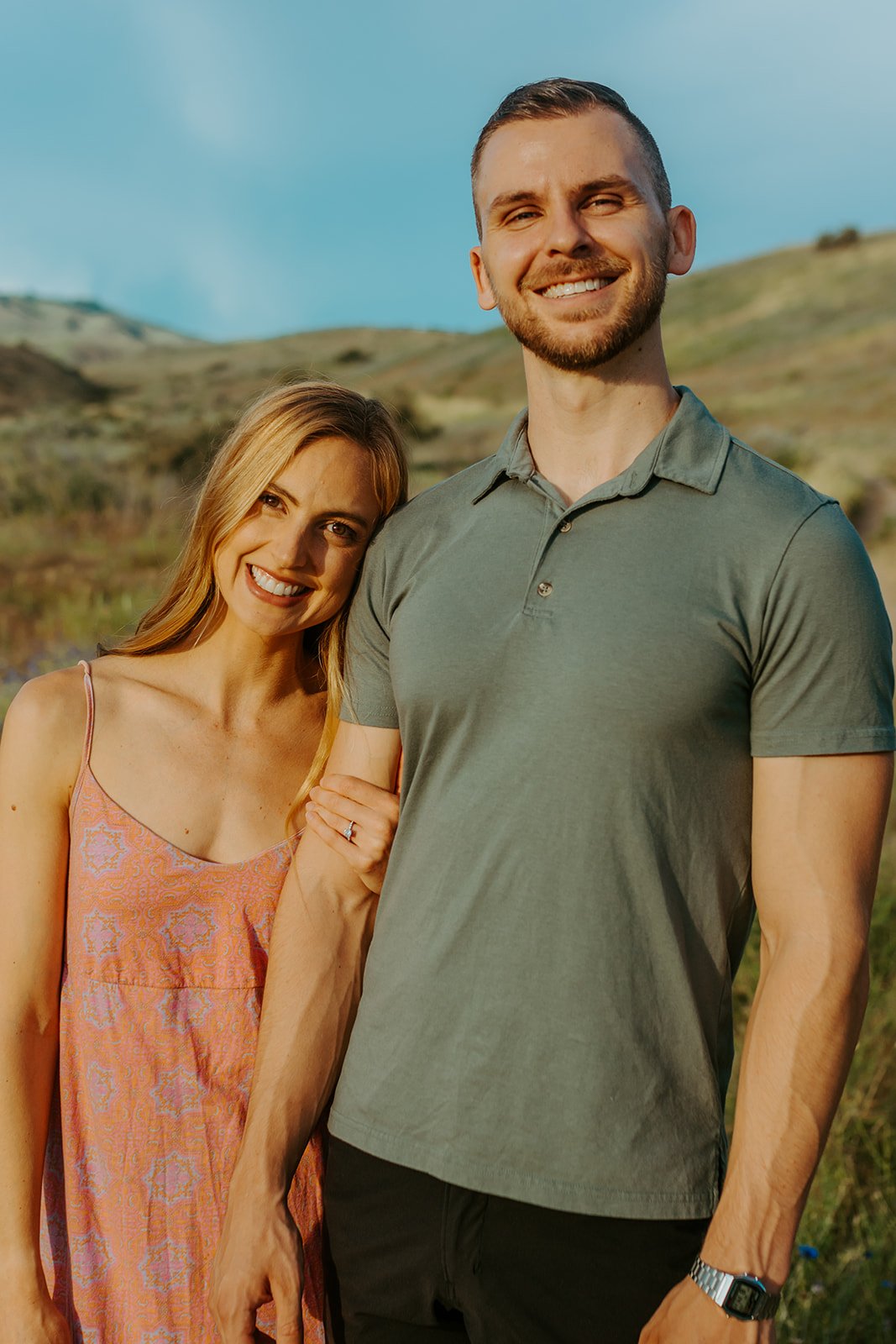 Idaho Summer Engagement Session her head rested on his shoulder as she grabs his arm with their second outfit change