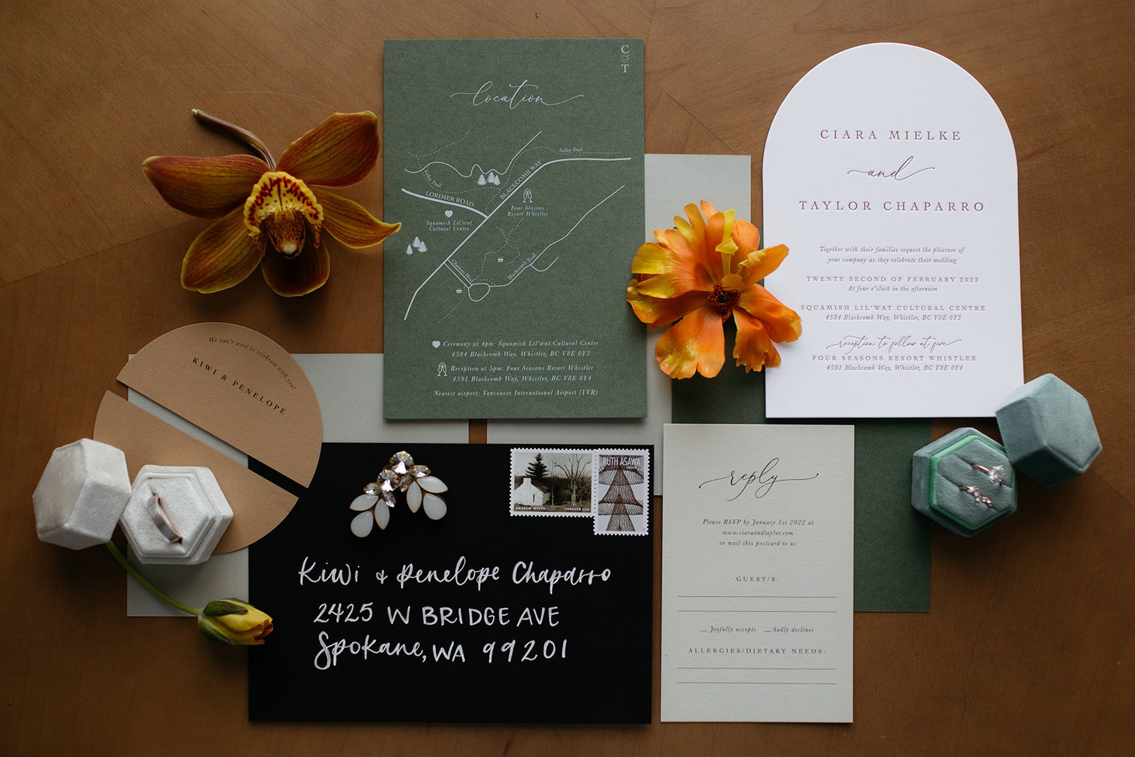 flatlay of wedding ring and stationery pieces for a Summer whistler wedding