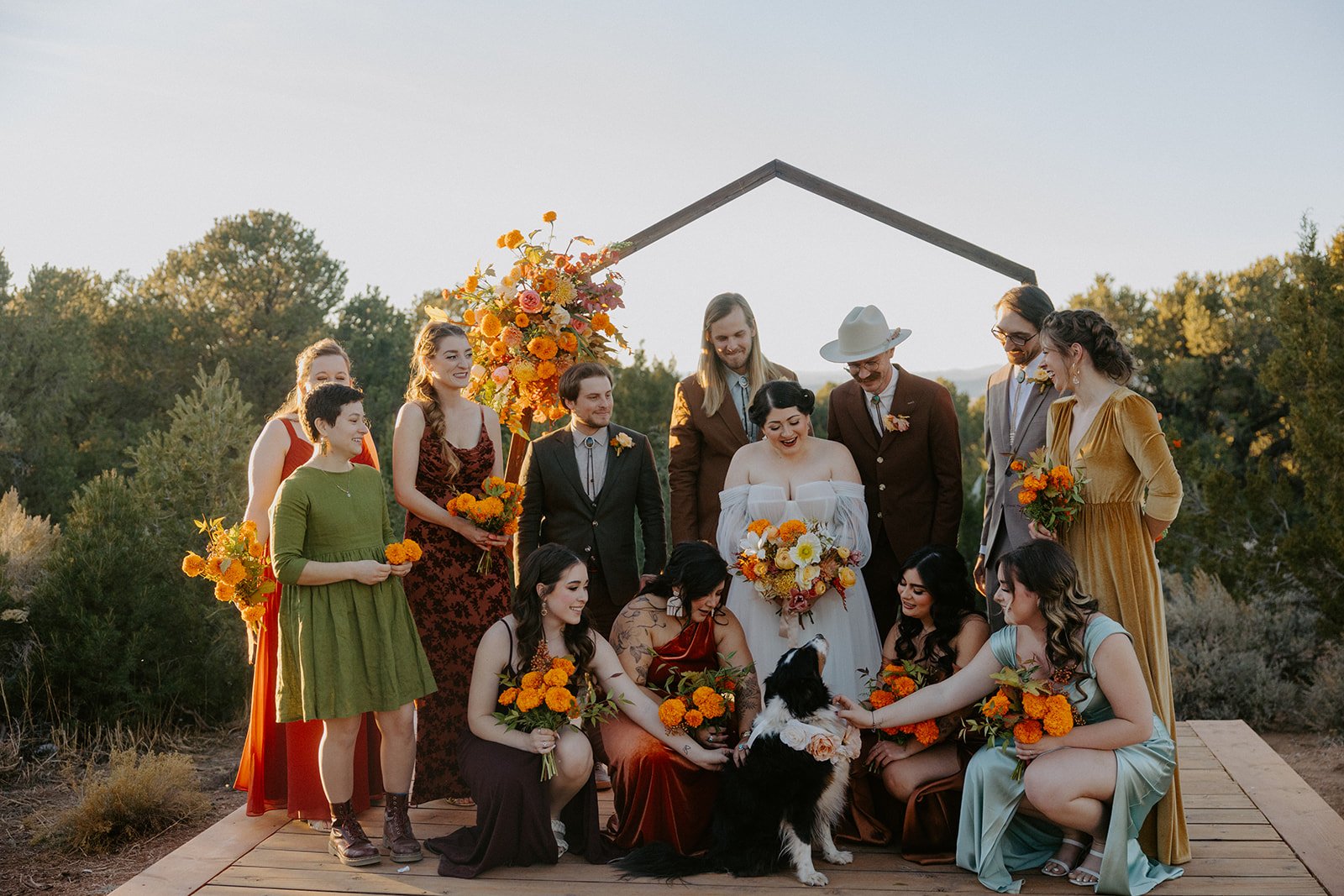 The Stakeout Taos Wedding bridal party showing love to the couple's dog at the ceremony site