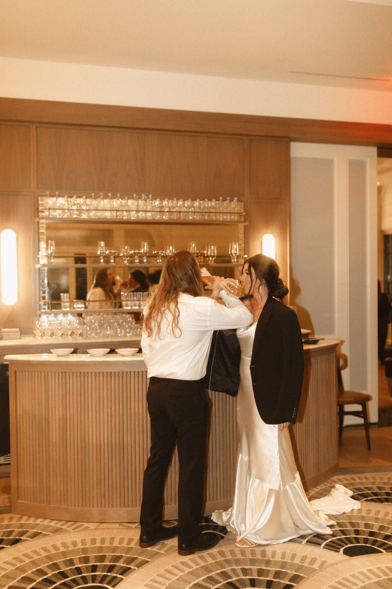 Salt Lake City Utah Wedding sharing a drink after their celebration in front of the hotel's bar