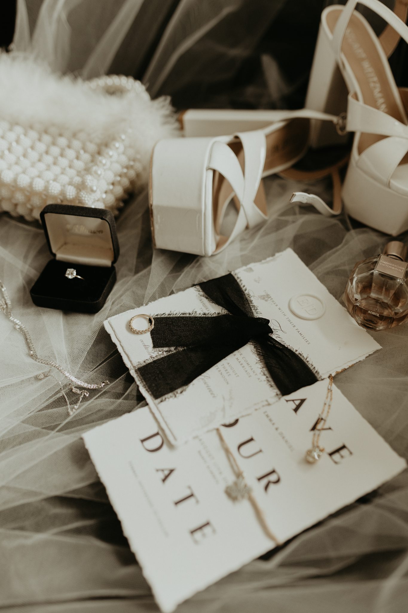 Fairmont Banff Springs Wedding details of their stationery, rings, perfume, purse, and heels for the wedding night