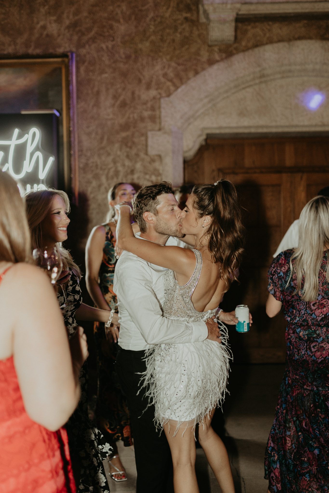Fairmont Banff Springs Wedding reception couple kissing in the middle of the dance floor while guests surround them and dance