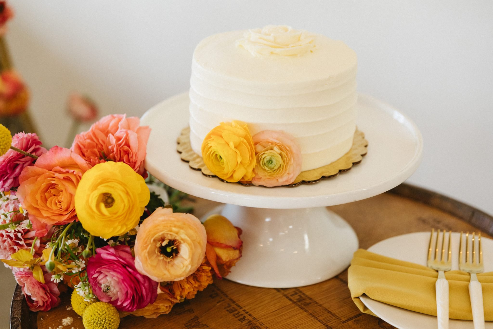 Bonnie Blue's Summer Wedding cutting cake decorated with an icing floral on top and yellow floral heads