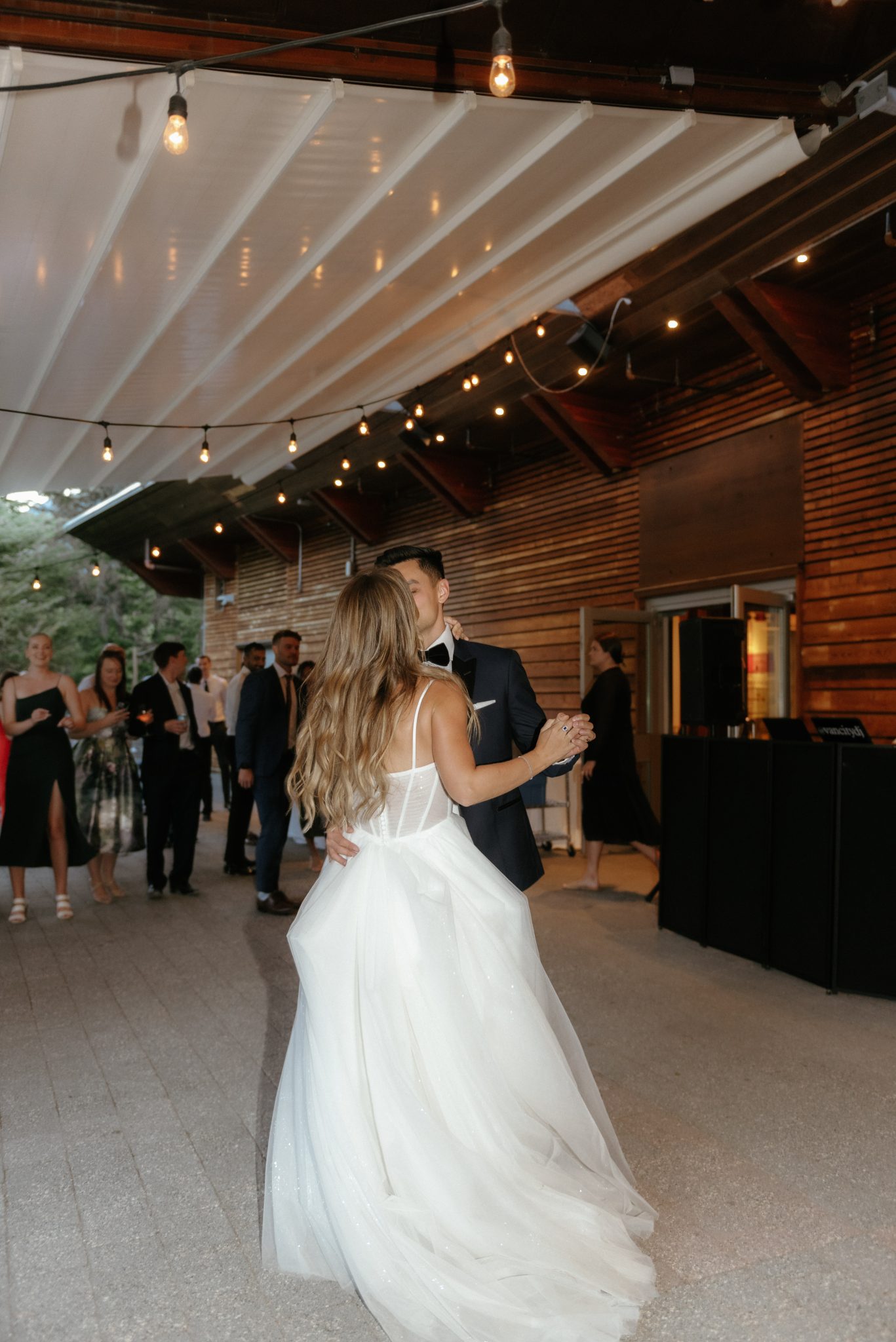 British Columbia Summer Wedding couple dancing under market lights for their first dance