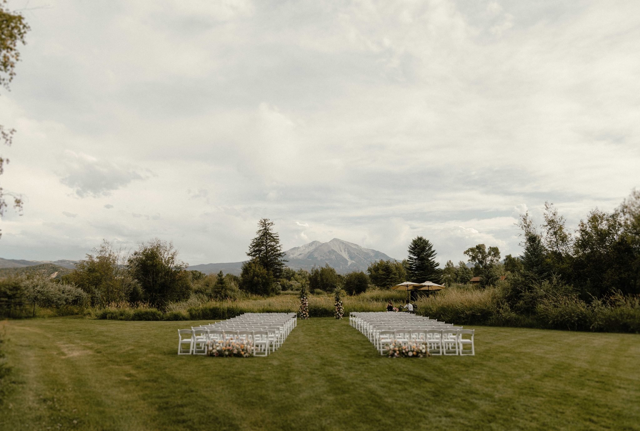 Carbondale Colorado Summer Wedding ceremony mountain backdrop with clouds rolling in for a moody effect