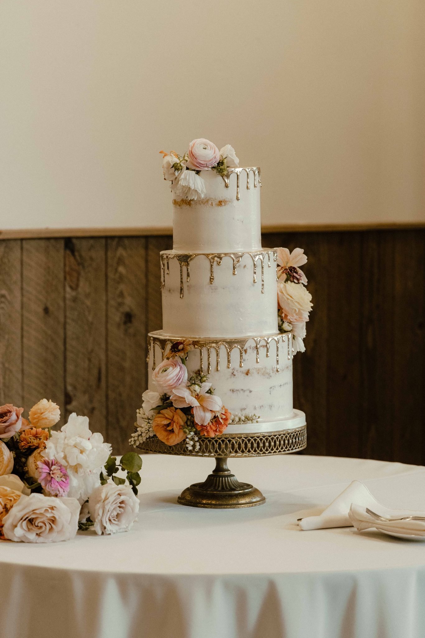 Carbondale Colorado Summer Wedding three tiered semi naked cake with gold icing dripping down the tiers