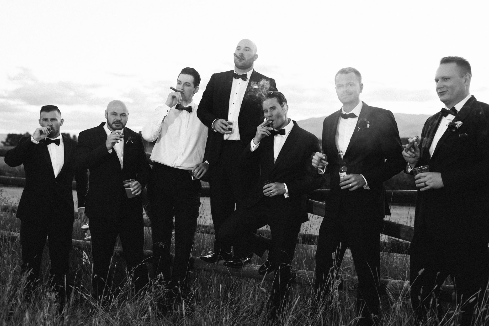 Copper Rose Ranch Wedding groomsmen with cigars on the ranch