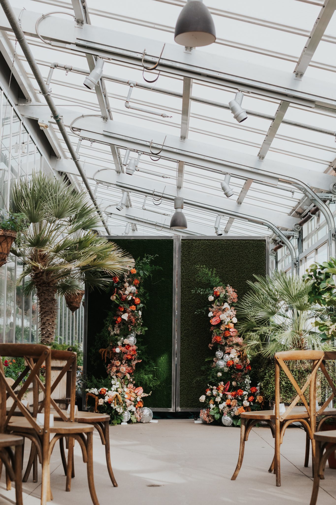 Denver Botanic Gardens Wedding colorful wedding floral arch with disco balls for the couple's ceremony backdrop