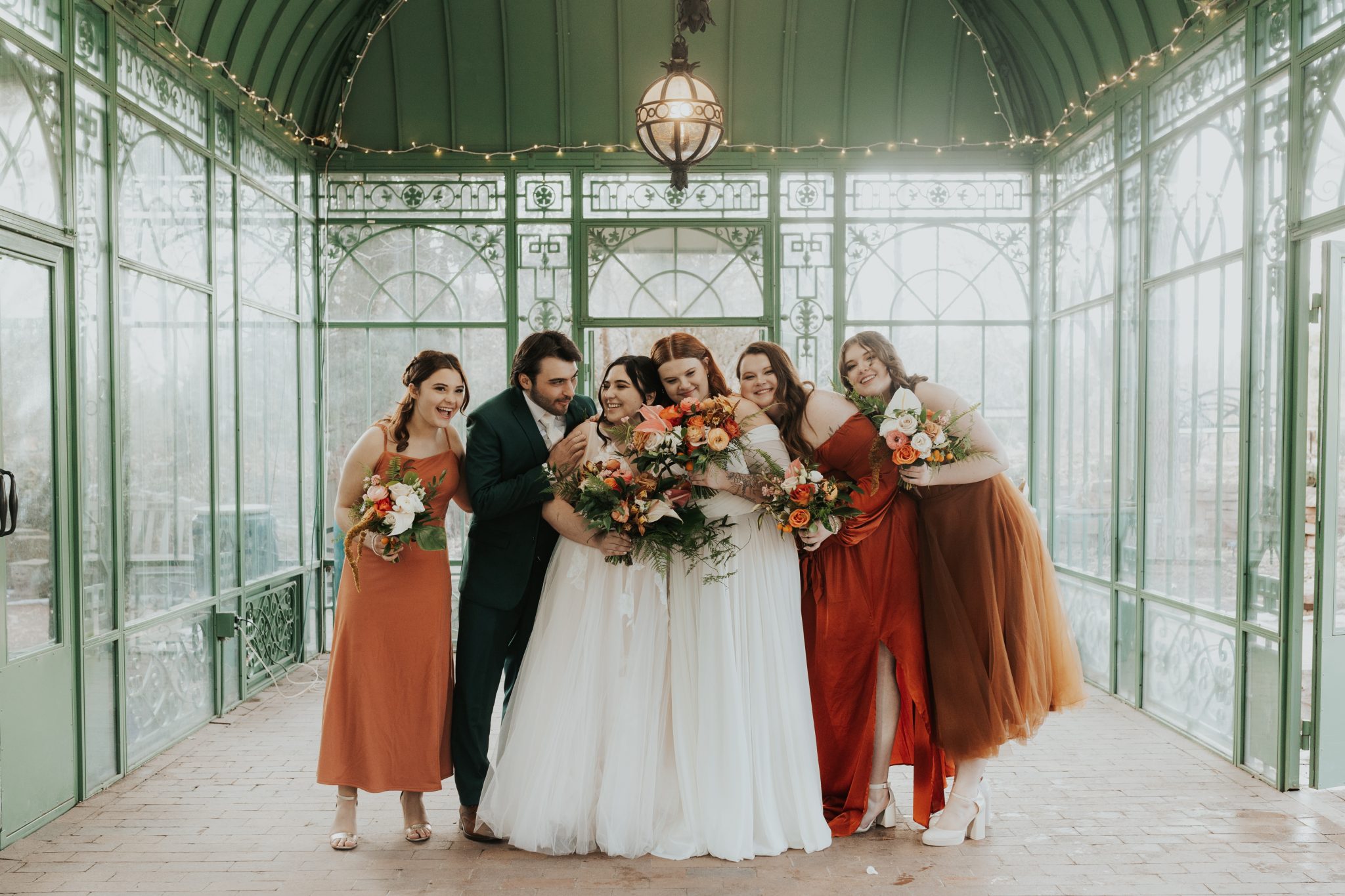 Denver Botanic Gardens Wedding bridal party wearing colorful bridesmaids dresses that perfectly match the wedding florals