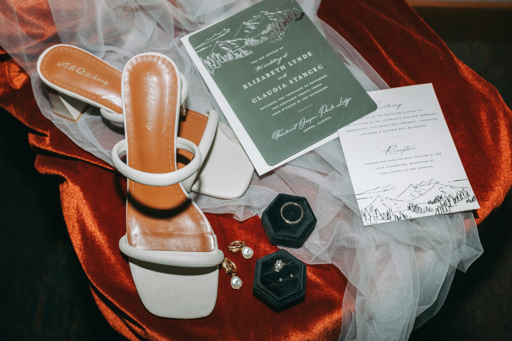 Fairmont Jasper Park Lodge Wedding details of shoes, veil, jewelry, rings, and invitation suite