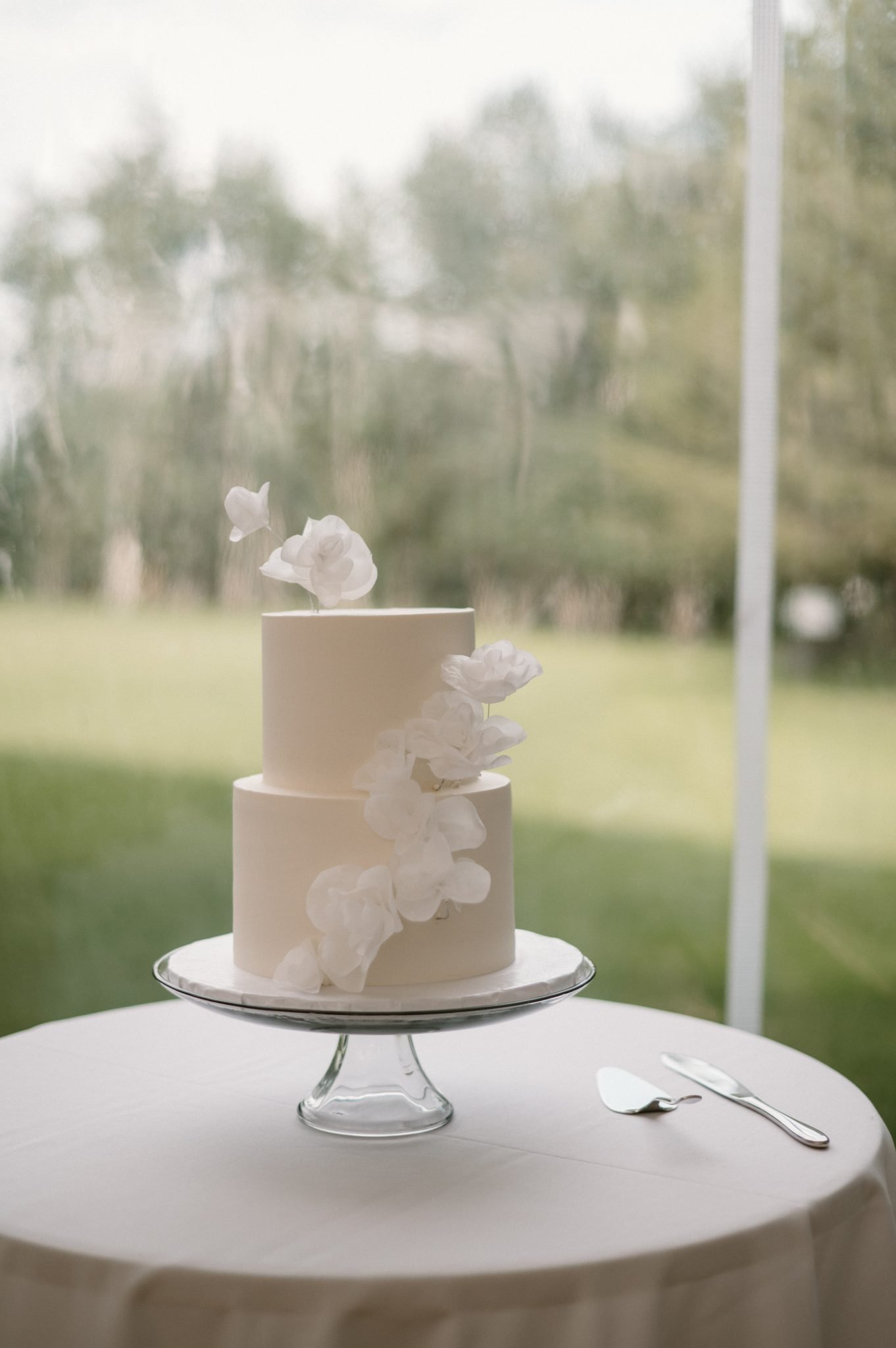 Hilltop Wedding Center Summer Wedding two-tiered wedding cake with elegant white florals