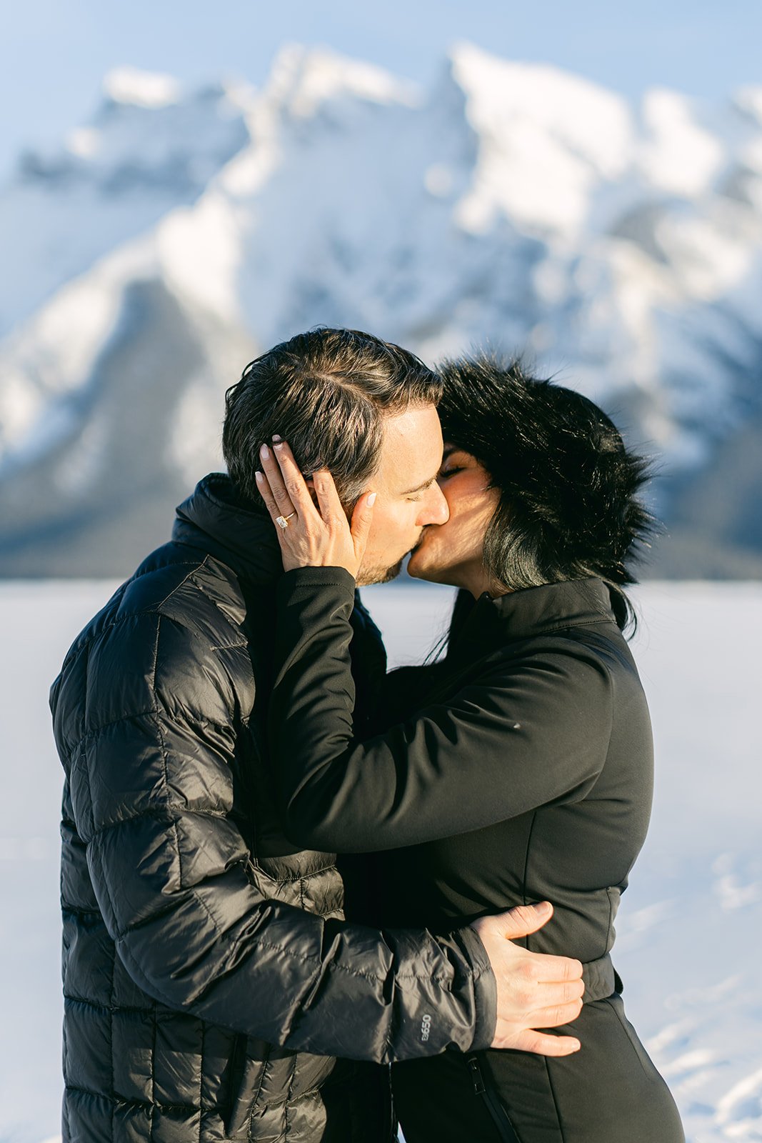 Alberta Wedding Proposal couple engaged with her hands on his face as she kisses him and his hands on her waist