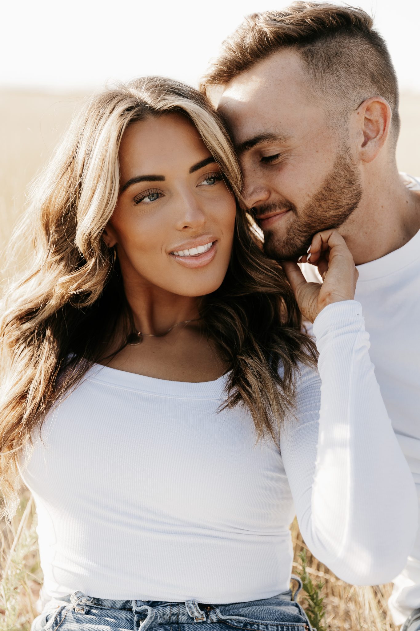 Utah Winter Engagement Session couple wearing white and jeans for casual attire