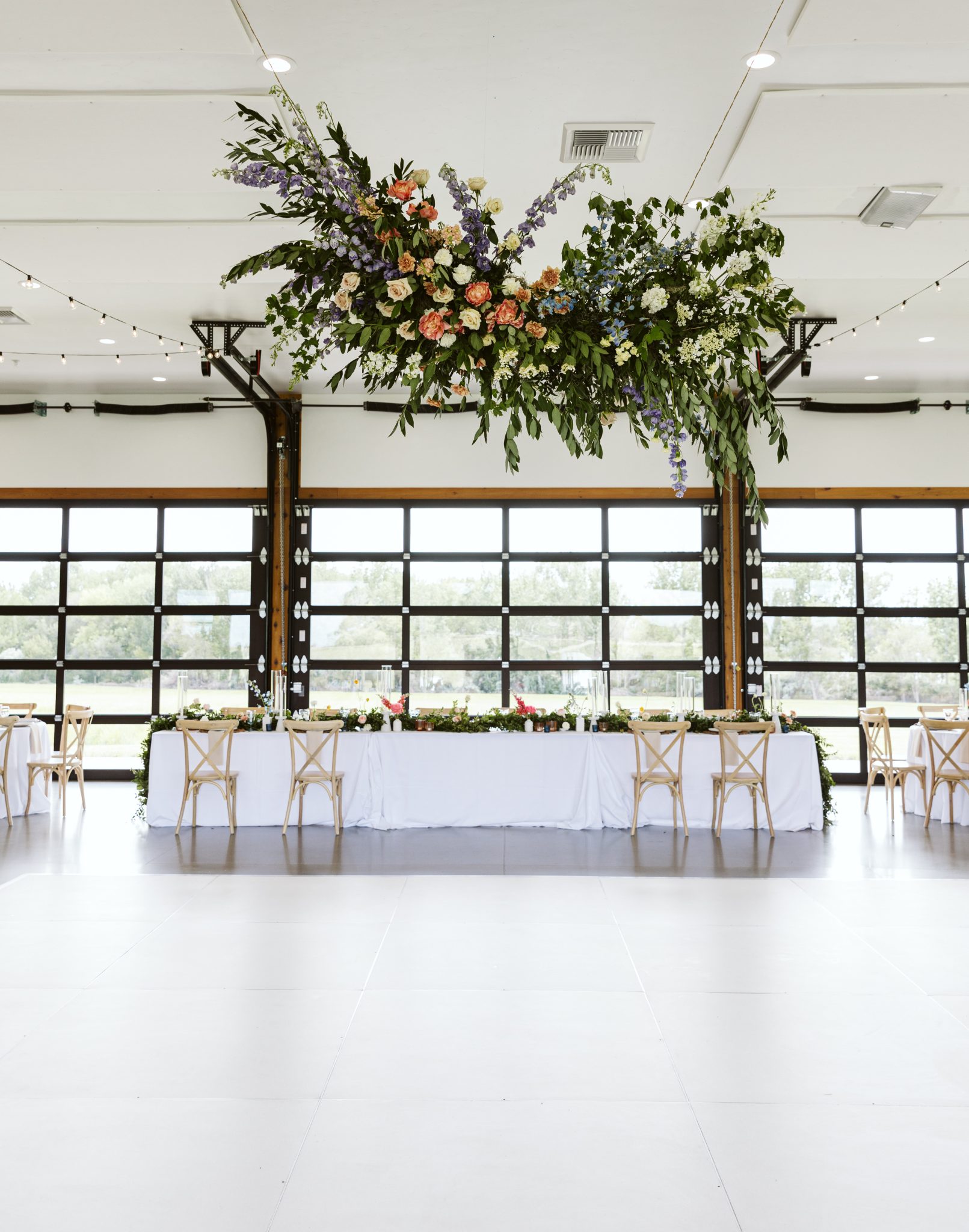Beautiful floral arrangements hanging above the reception area at Deer Flat Ranch Spring Wedding.