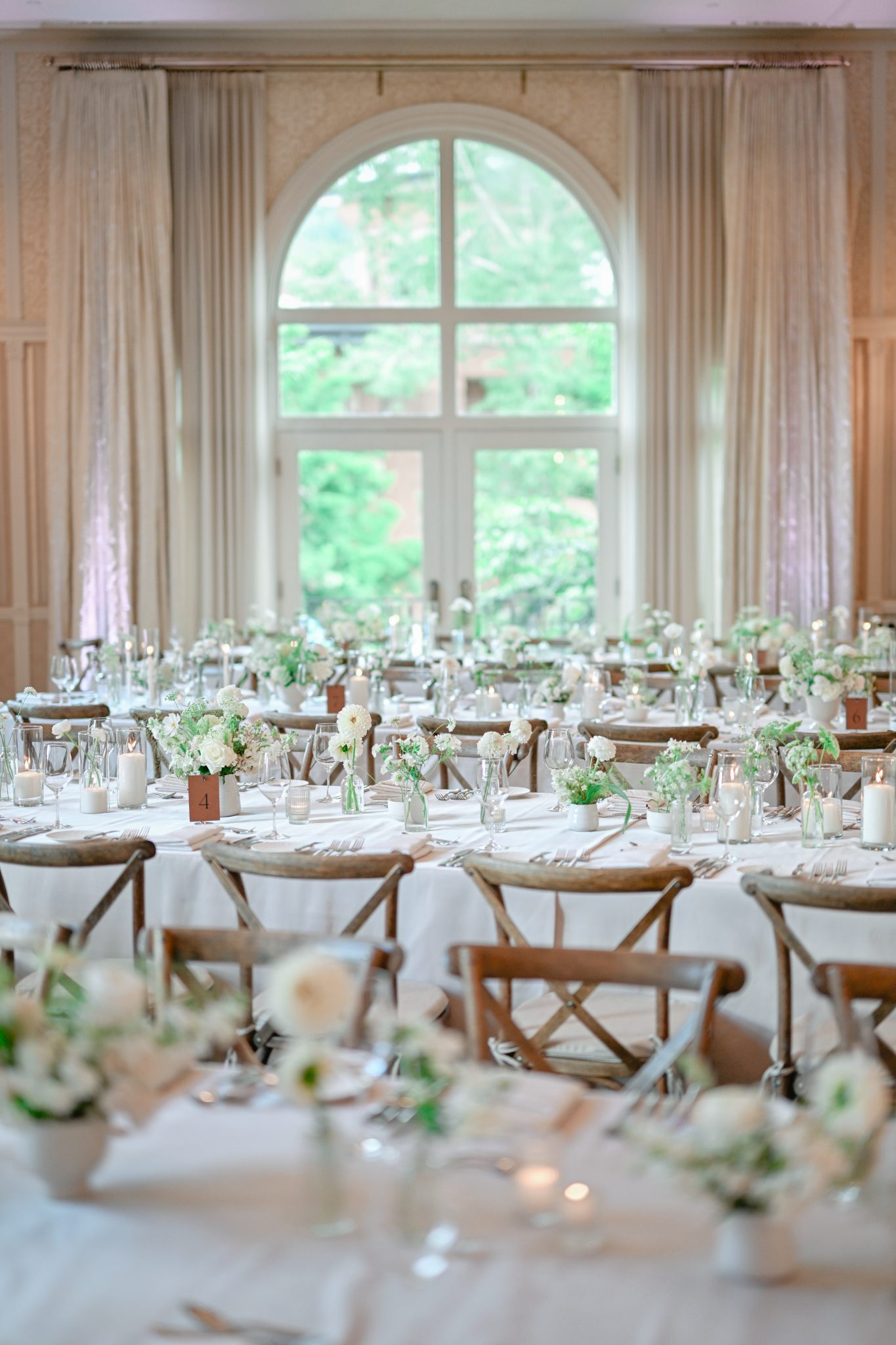 Elegant reception setup with white floral arrangements at Hotel Jerome wedding.