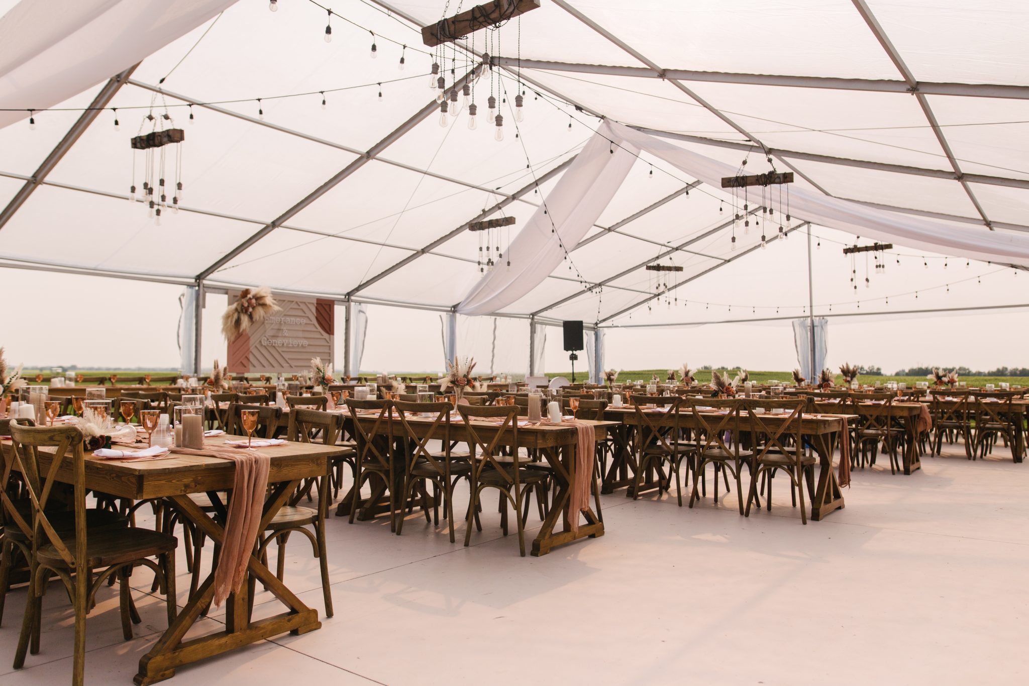 Elegant reception setup under a transparent tent at a LGBTQIA+ Alberta Summer Wedding