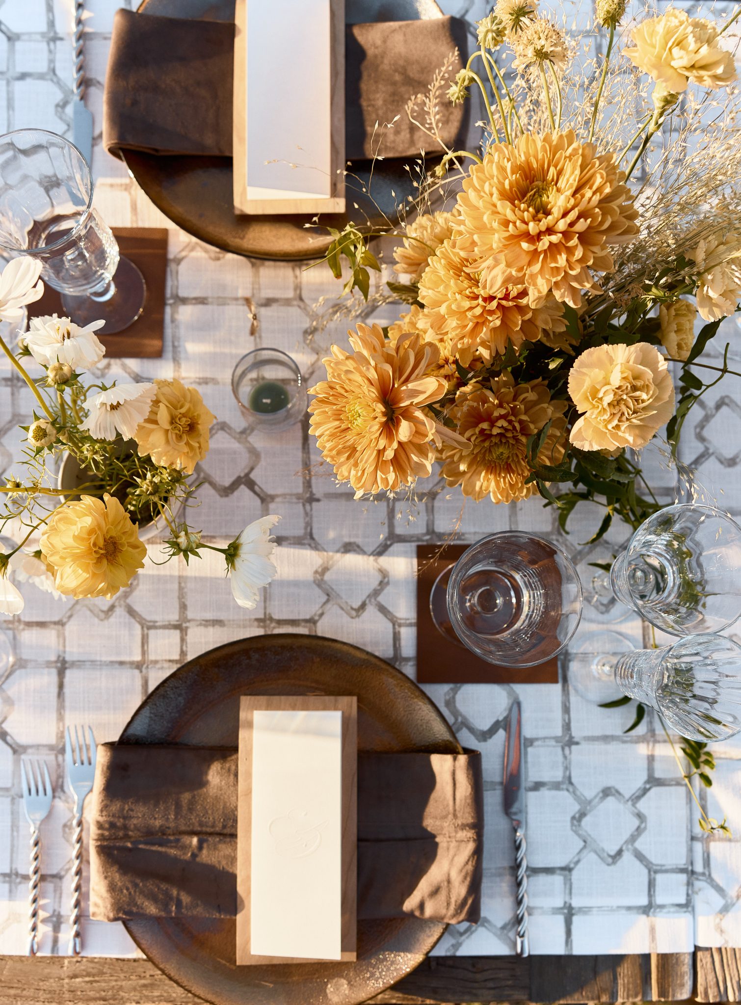 Rustic table setting with floral centerpiece at a Montana summer wedding.