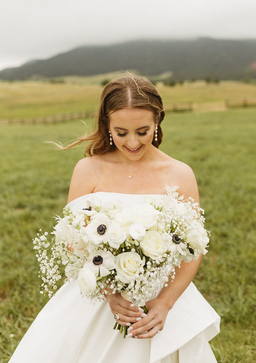 Bride holding a bouquet of white flowers at Spruce Mountain Ranch Summer Wedding.